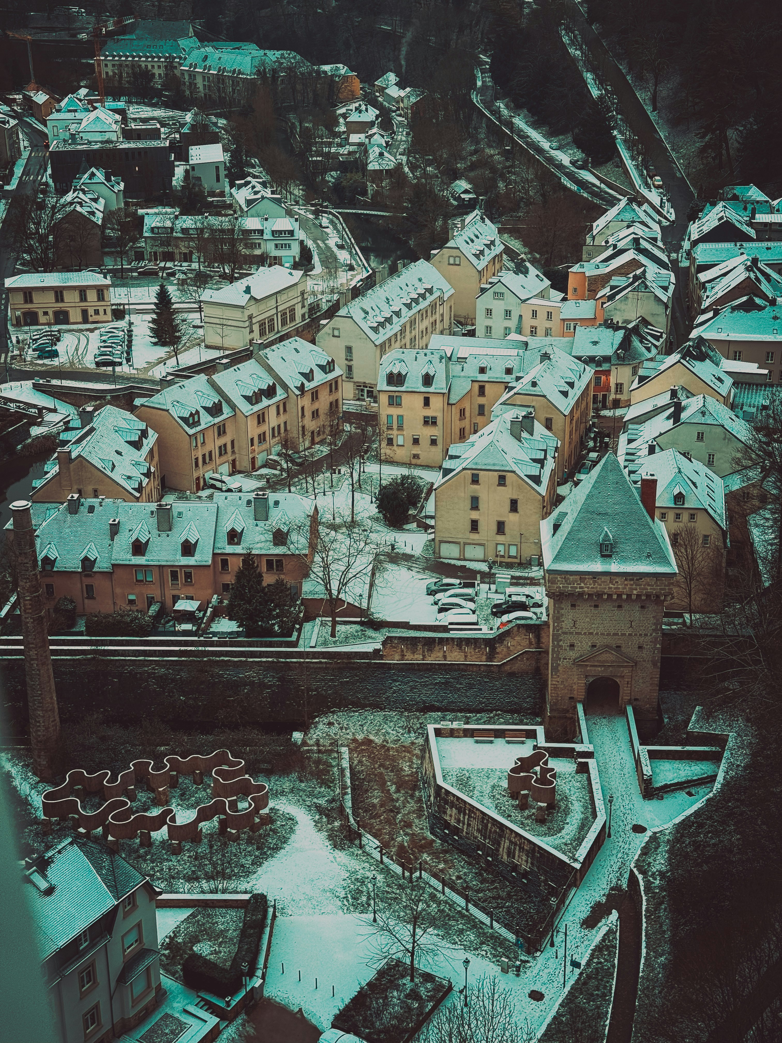 Snow-covered town with historic tower and buildings.