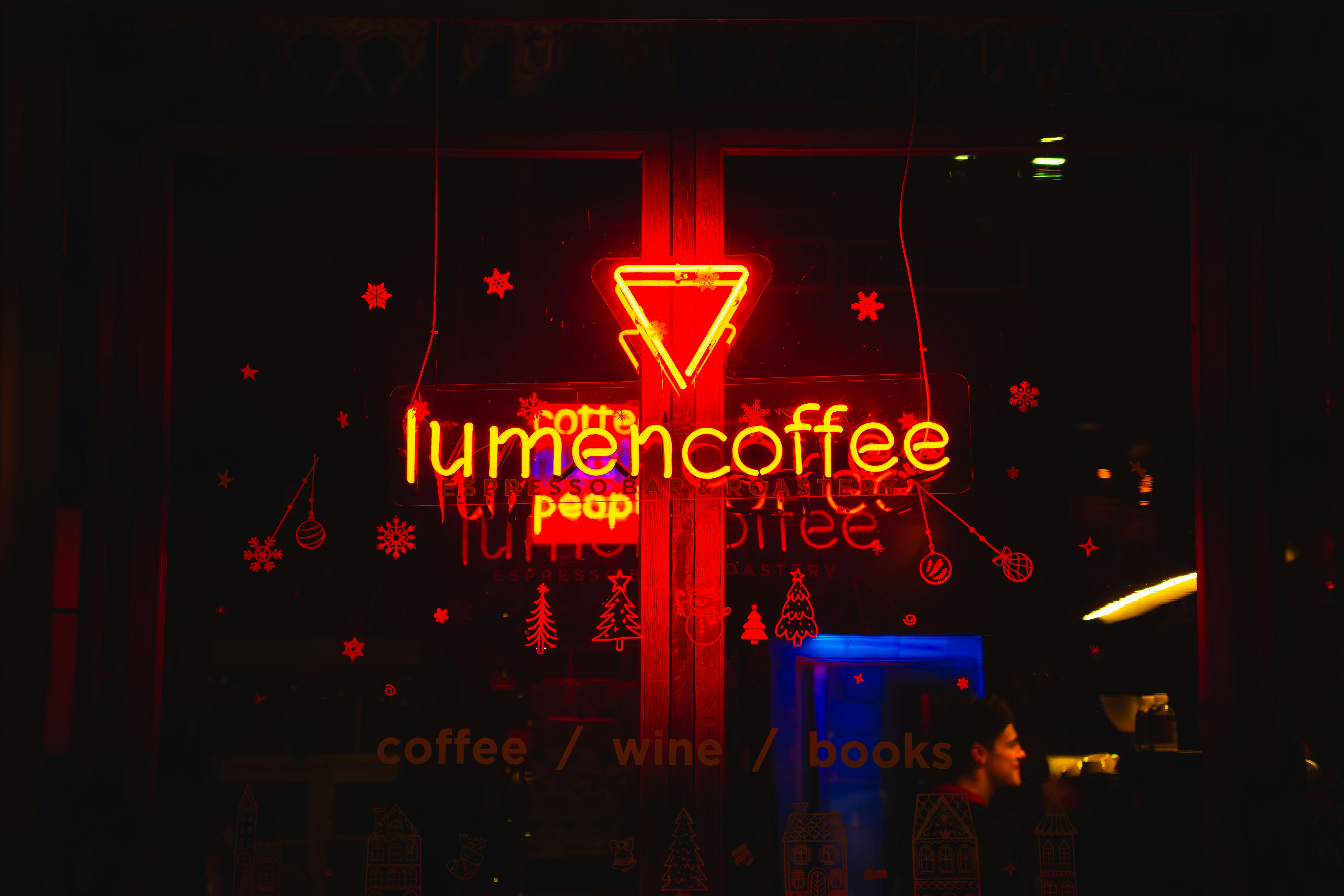 Neon sign for lumencoffee with coffee, wine, books