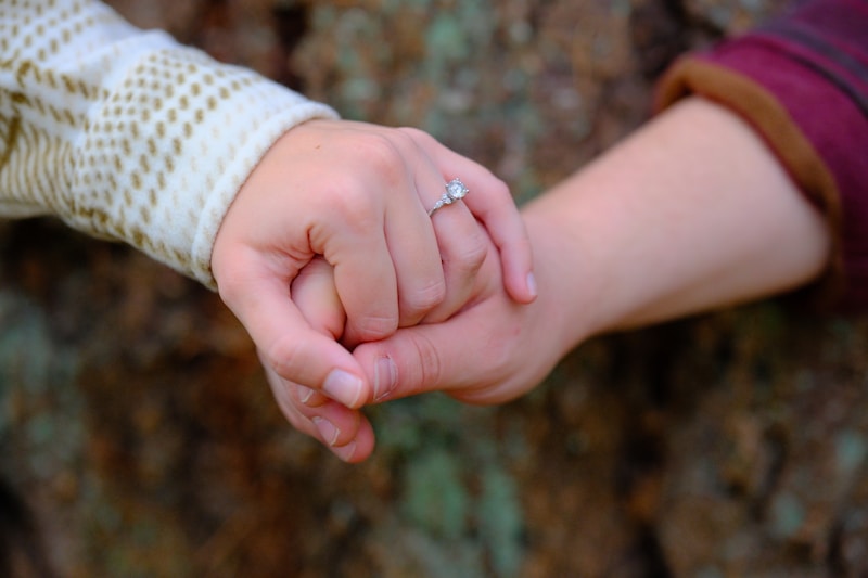 Couple's hands together with sparkling engagement ring