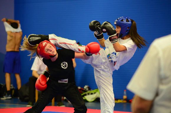 Two girls sparring in a martial arts class