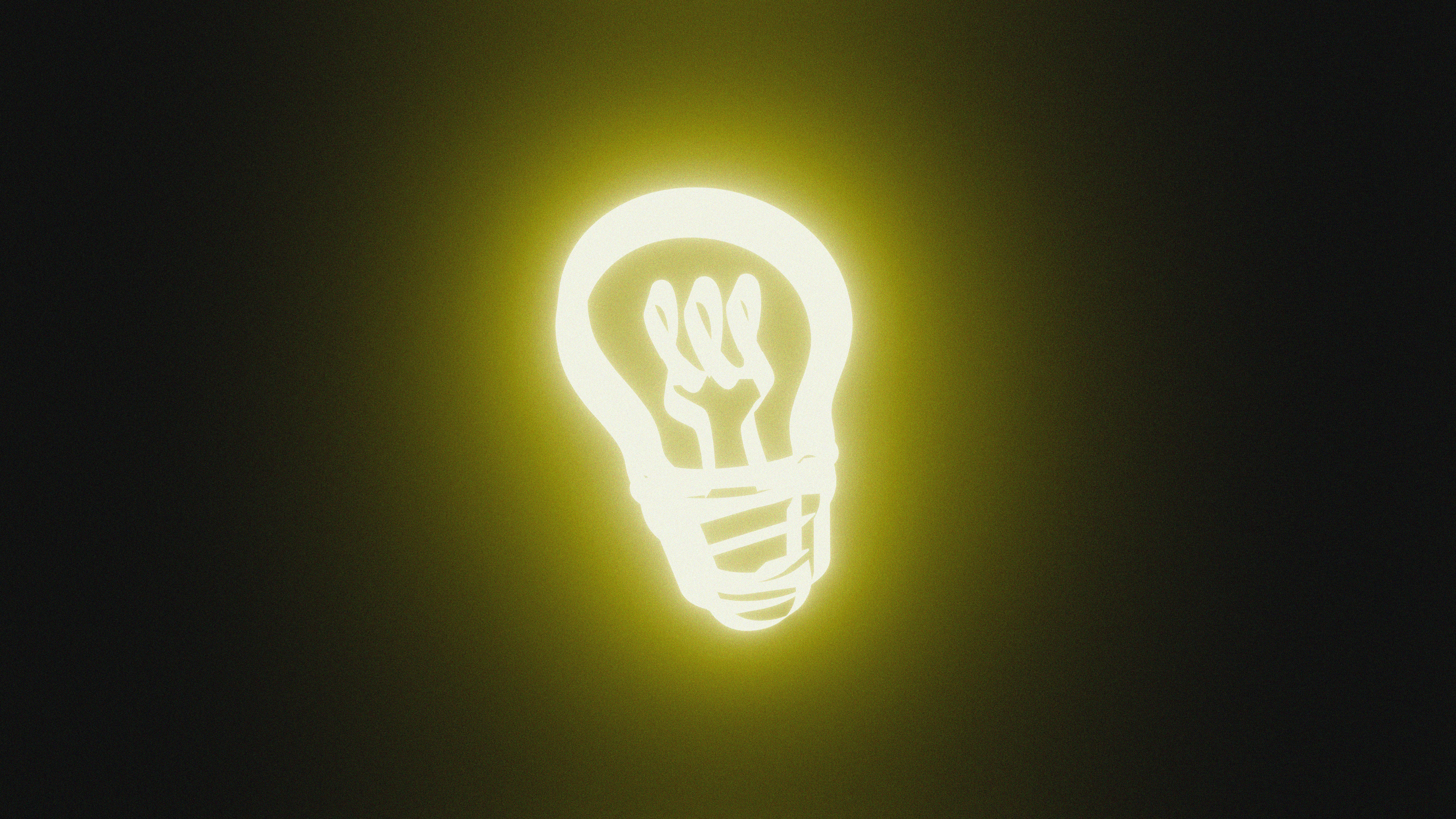 A glowing light bulb on a dark background