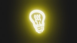A glowing light bulb on a dark background
