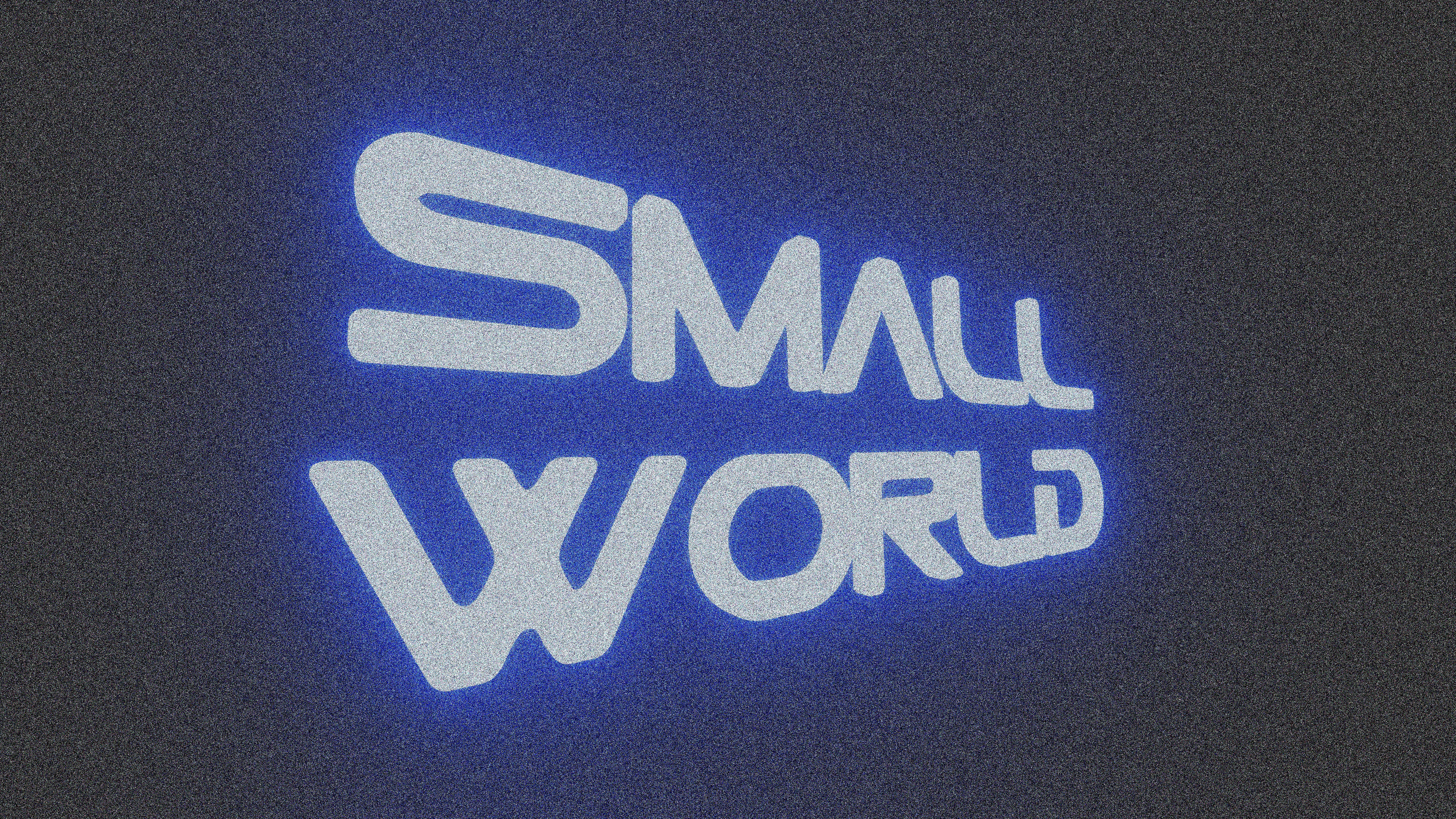 The words small world illuminated in blue light.