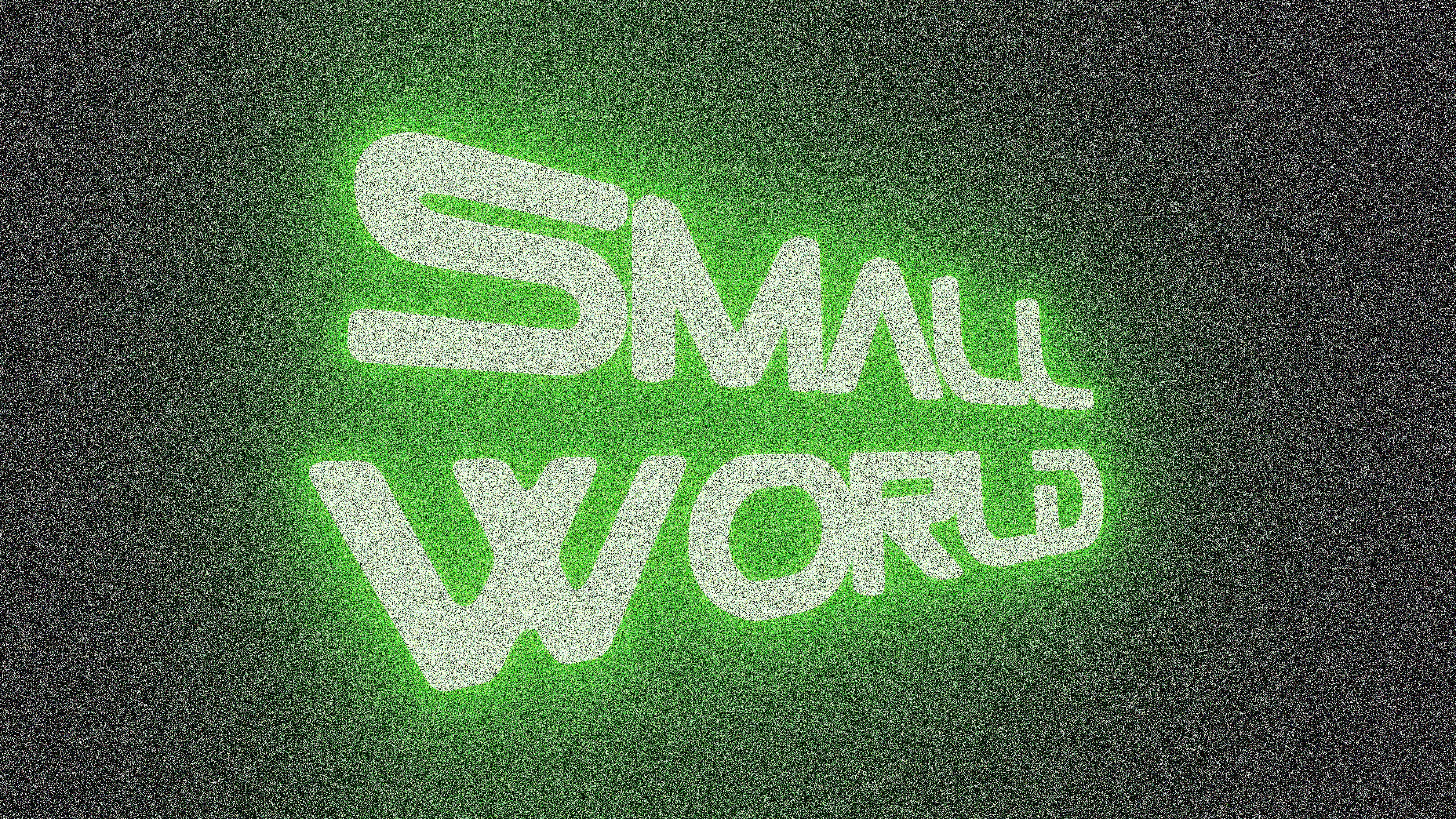 Green neon text that says small world