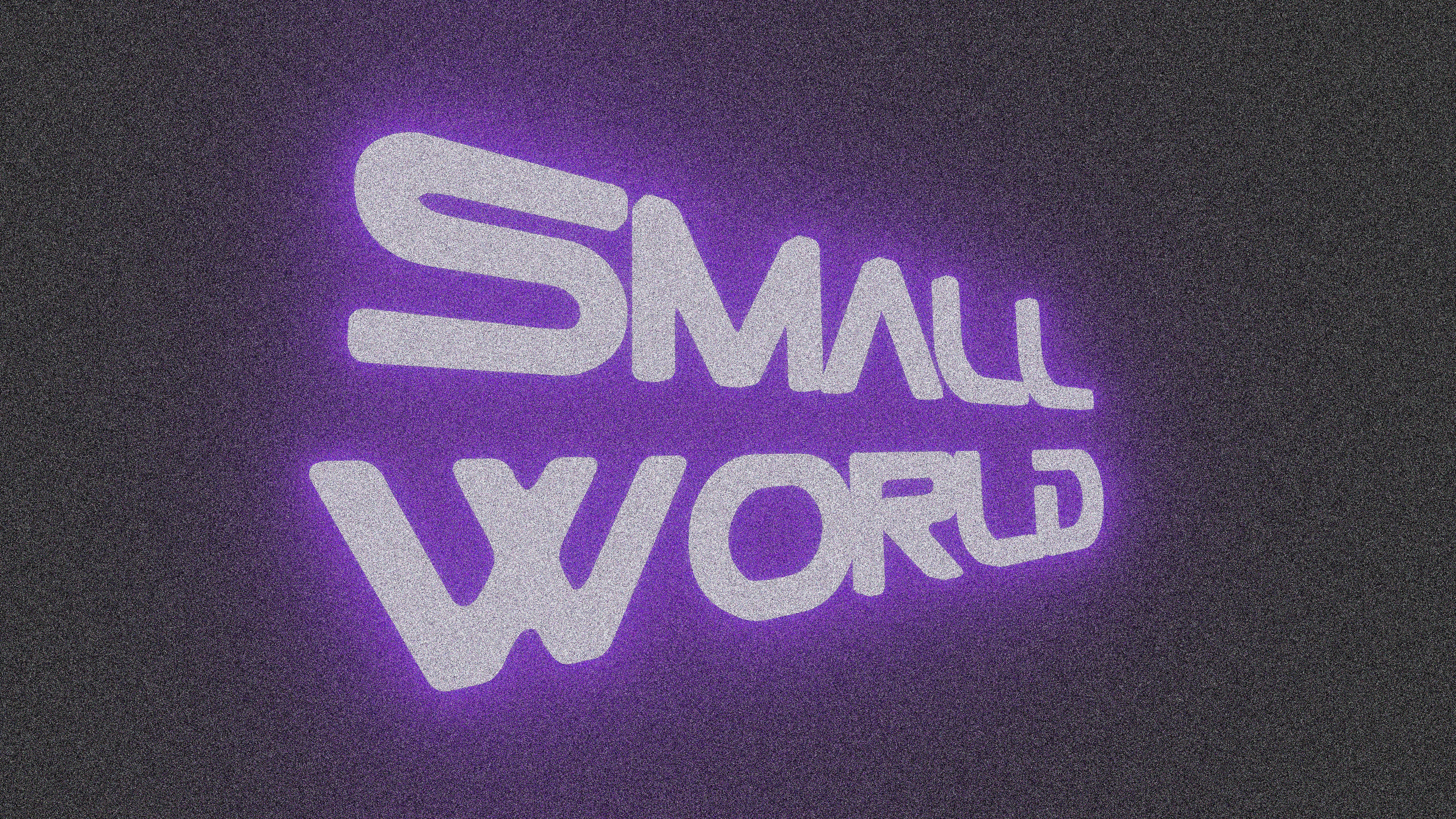The words small world in purple neon light.
