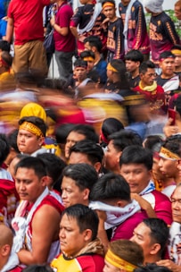 Crowd of people in religious procession wearing headbands