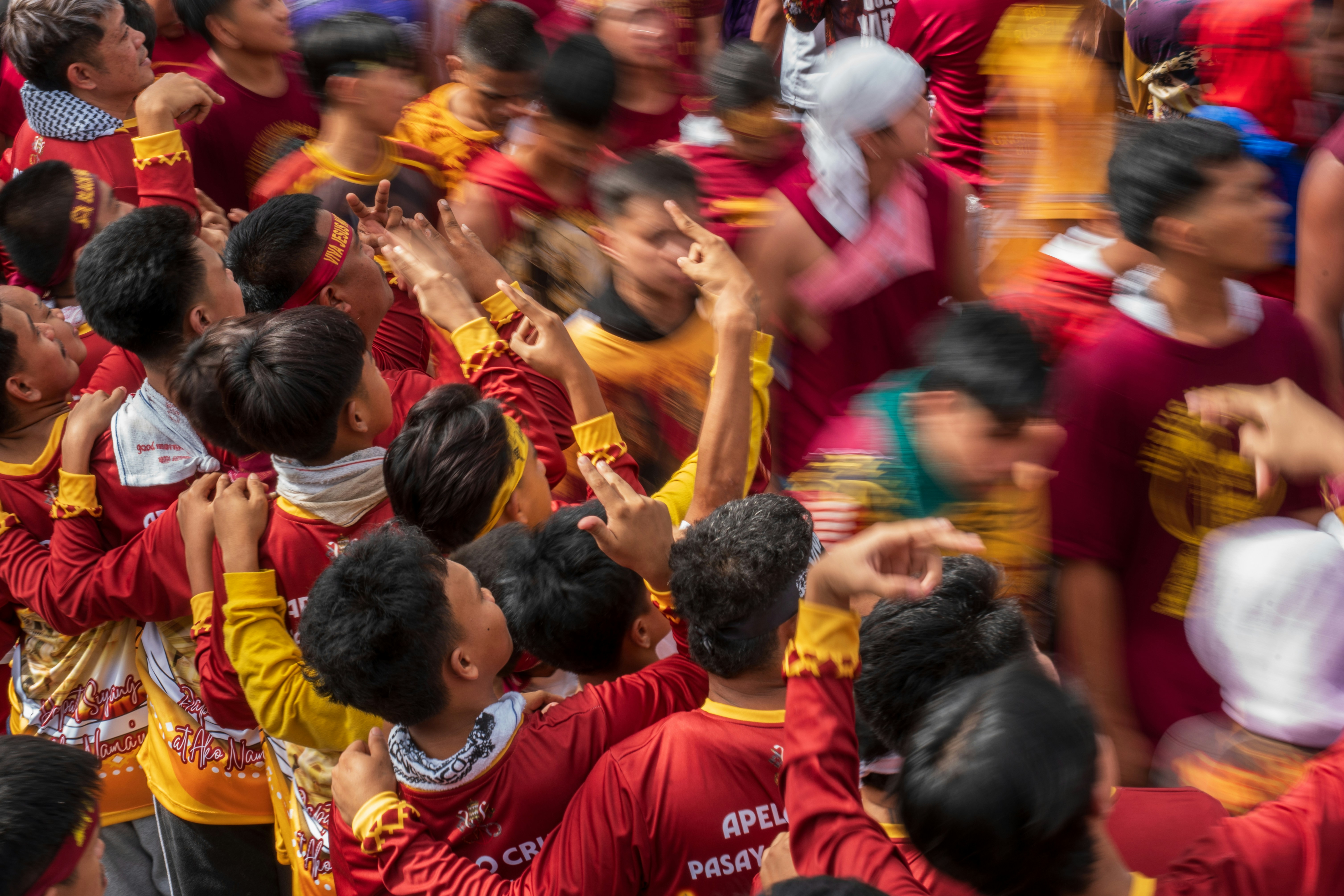Crowd of people in red shirts with blurred motion.
