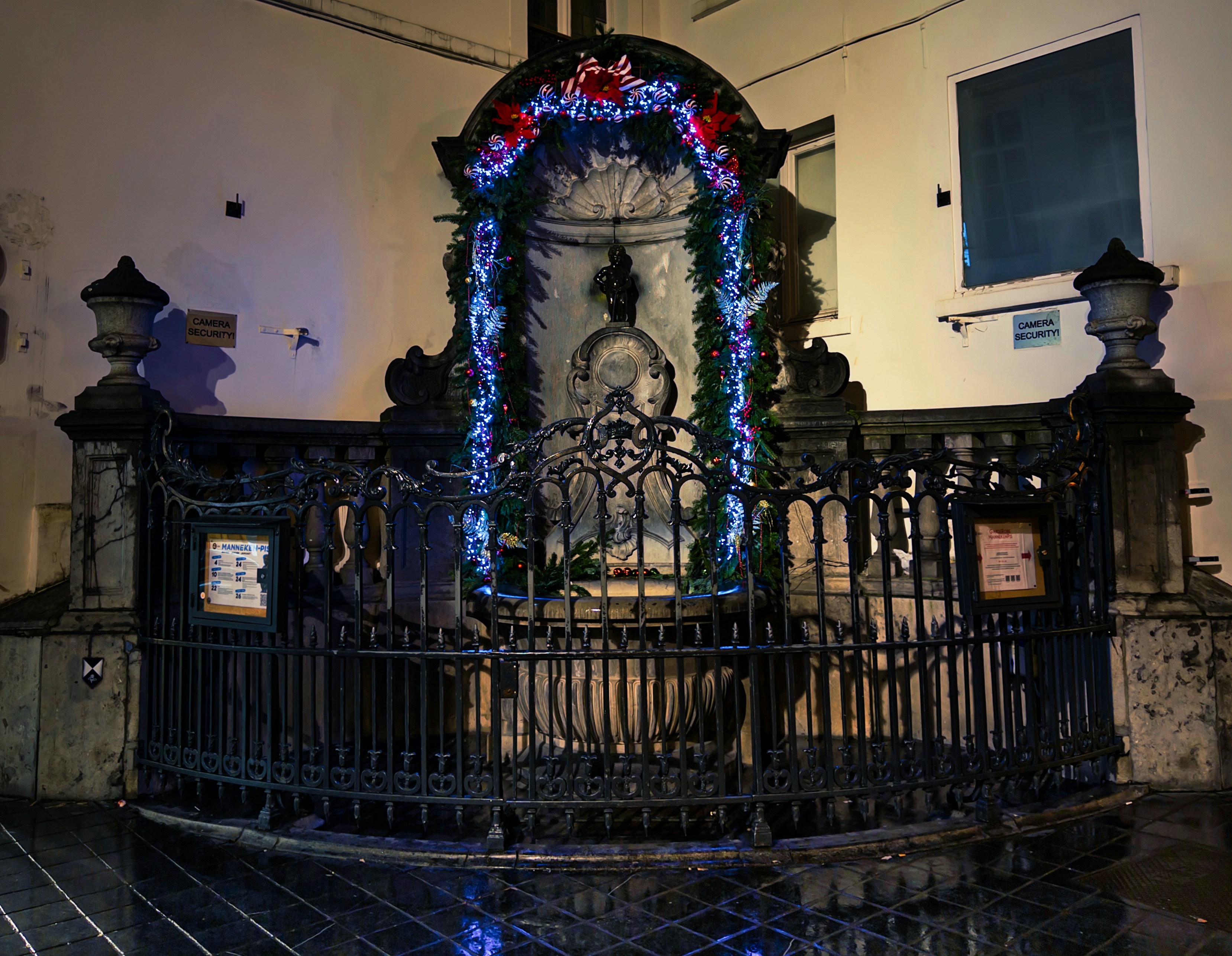 Ornate fountain decorated with festive christmas lights.