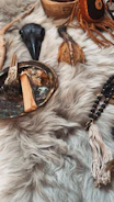 Various spiritual objects arranged on a furry surface