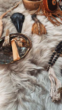 Various spiritual objects arranged on a furry surface