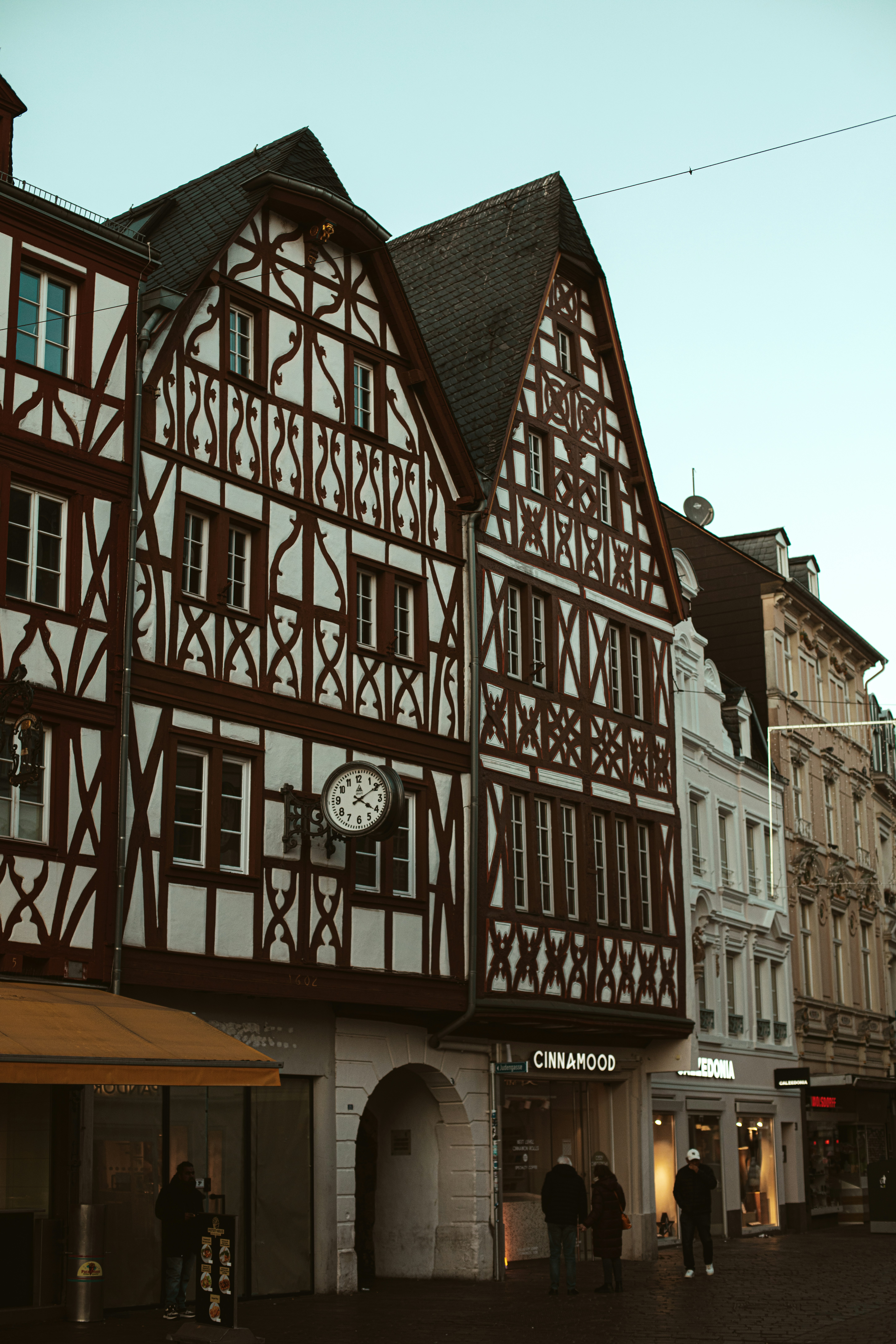 Half-timbered buildings line a european street.
