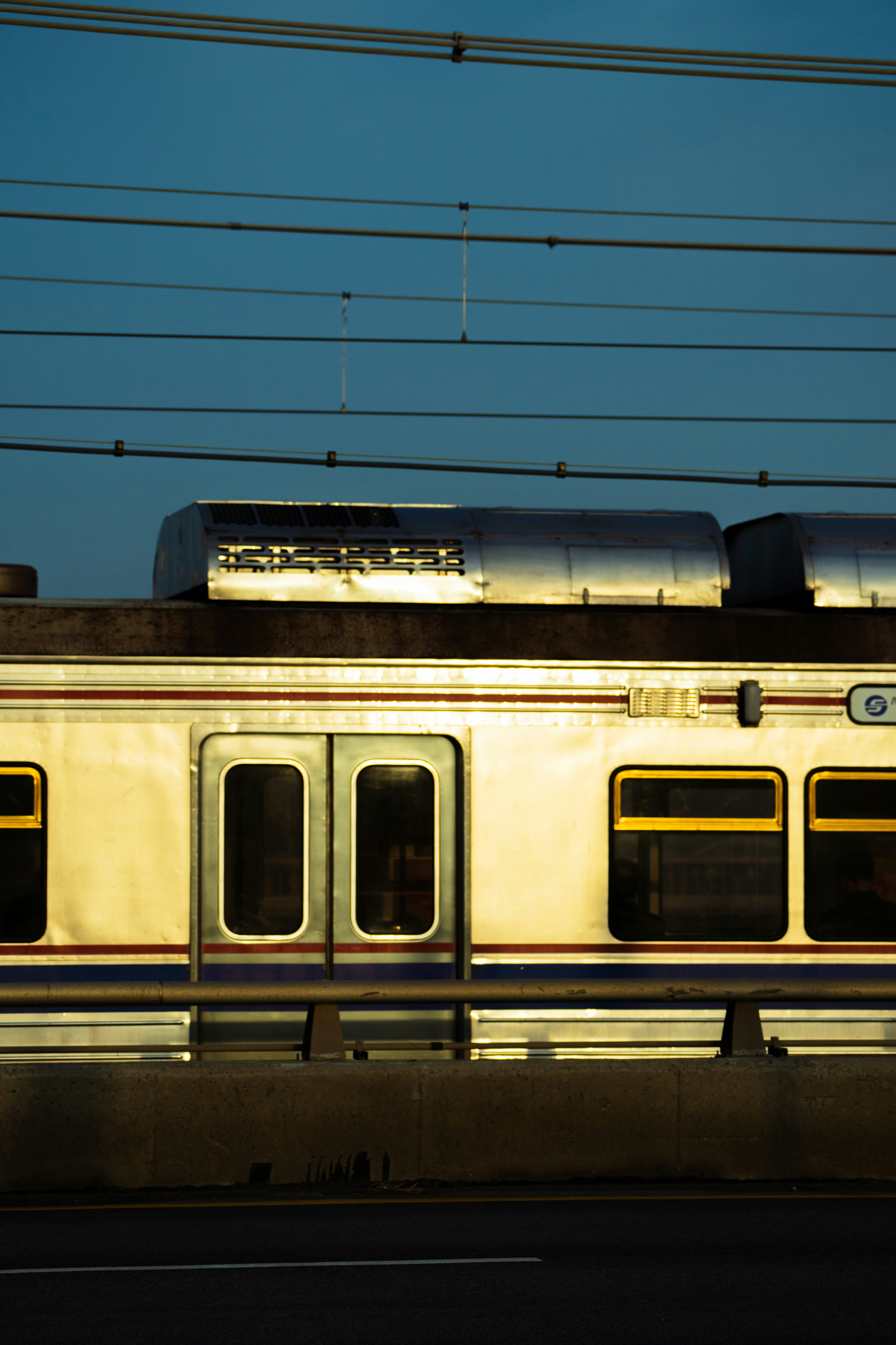 A train car with yellow-trimmed windows.