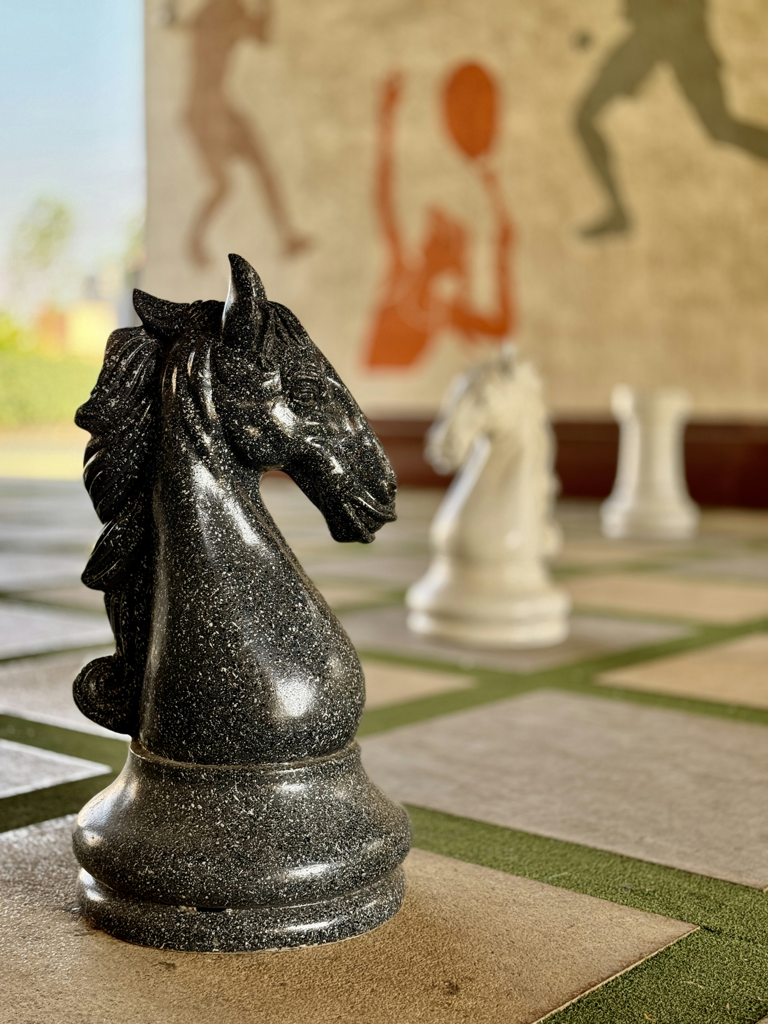 Stone chess pieces on a large board
