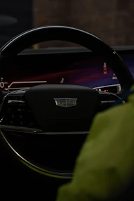 Close-up of a modern car's steering wheel and dashboard.
