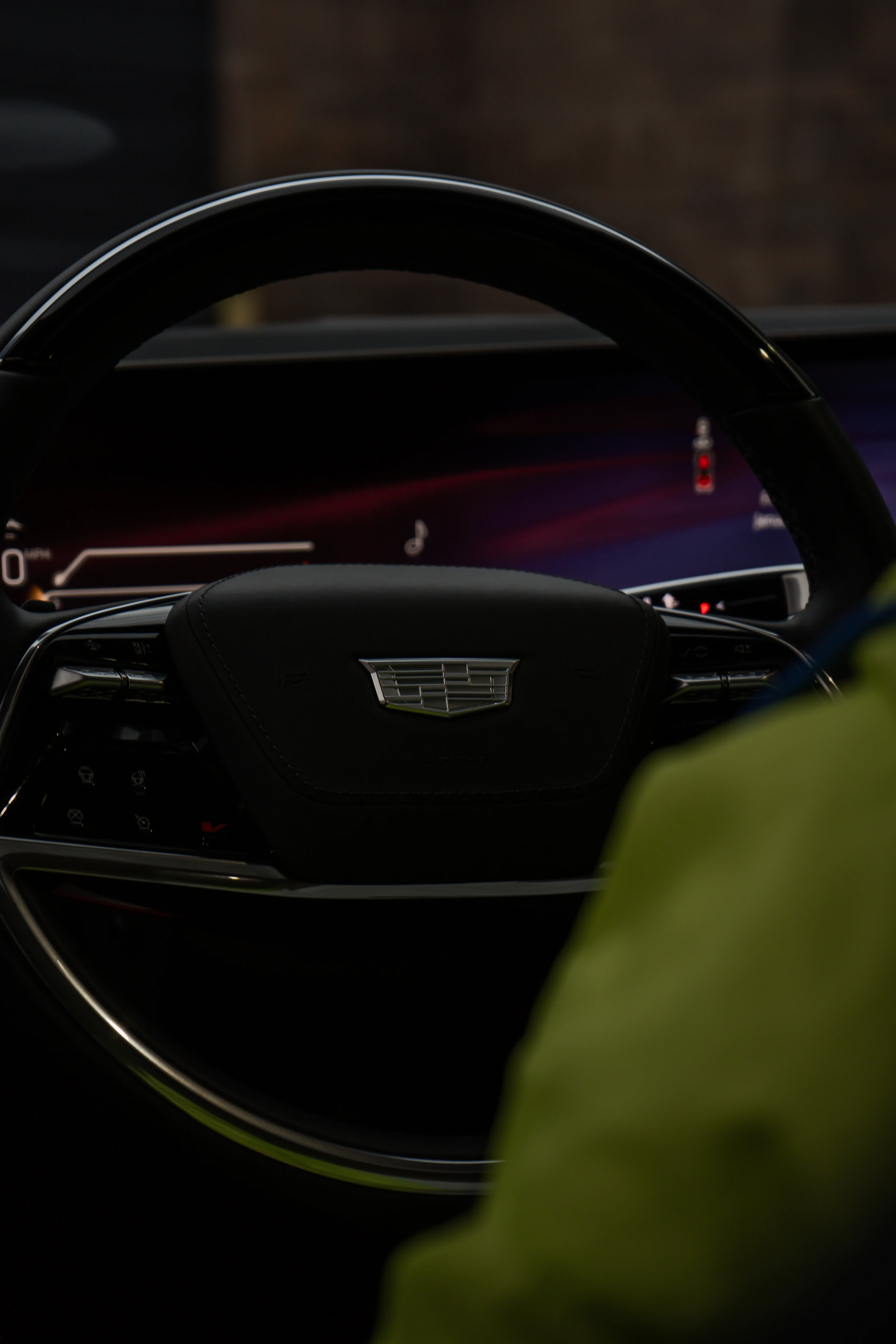 Close-up of a modern car's steering wheel and dashboard.