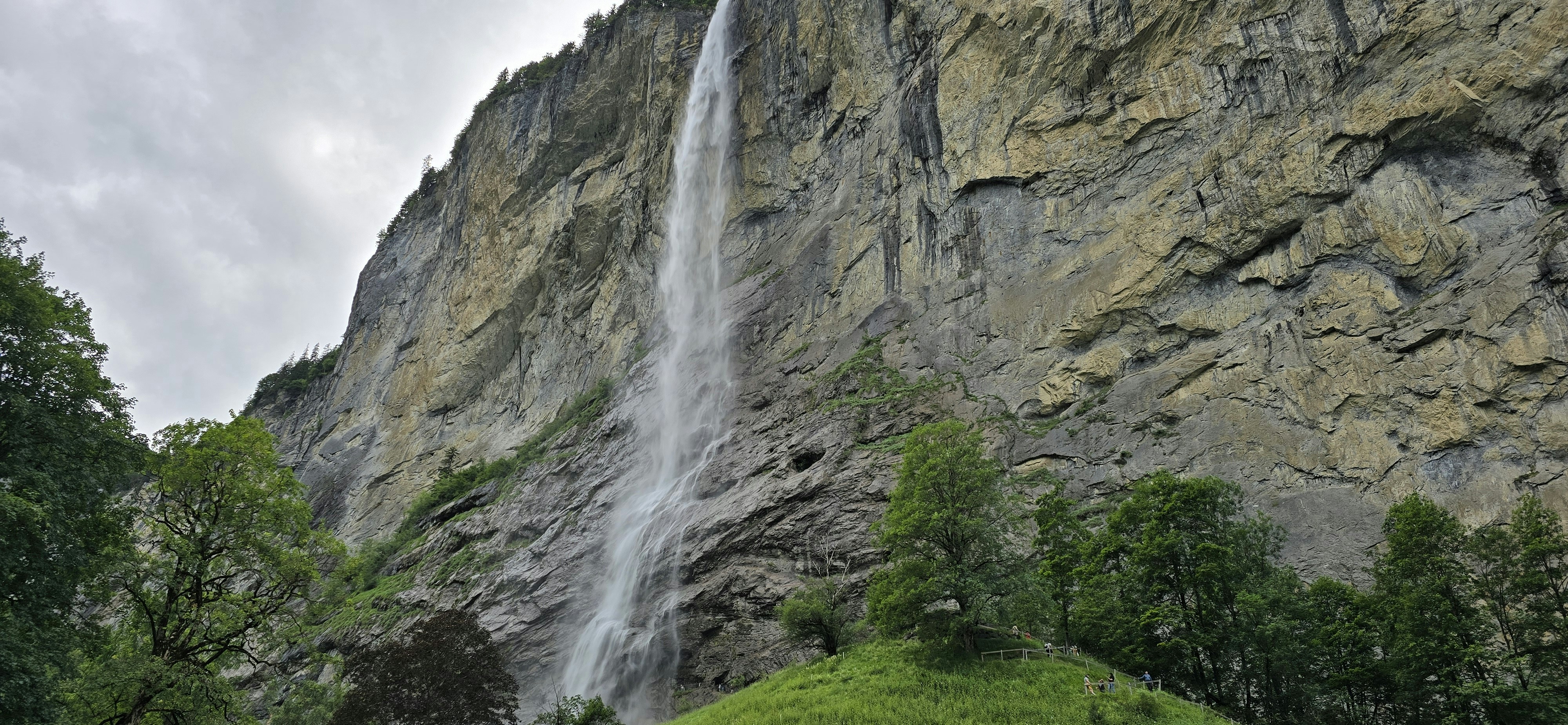 Tall waterfall cascading down a rocky cliff face