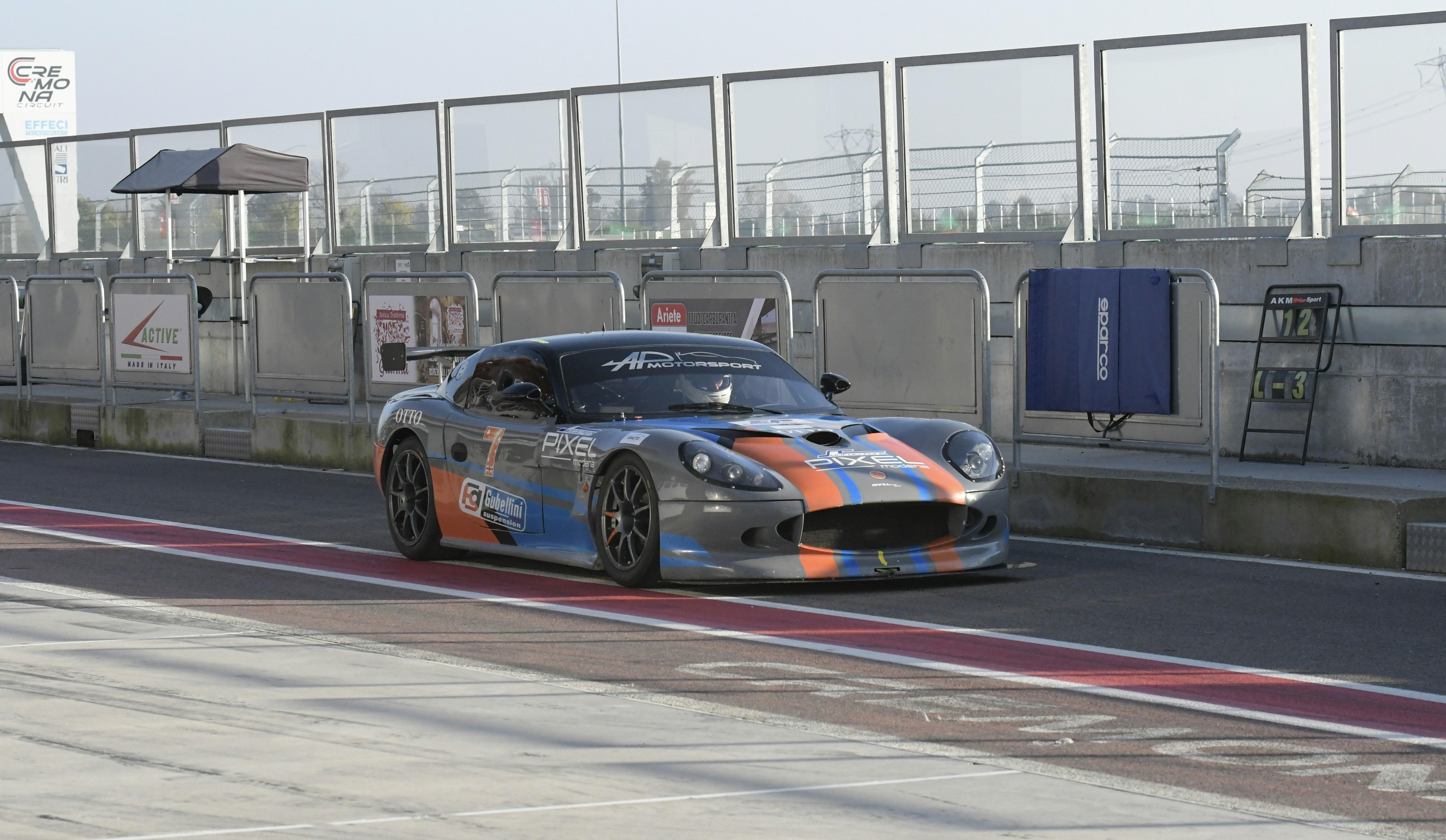 A race car drives down a track.