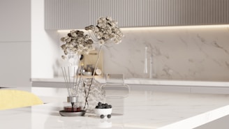 Dried flowers and berries on a marble countertop.