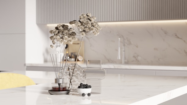 Dried flowers and berries on a marble countertop.