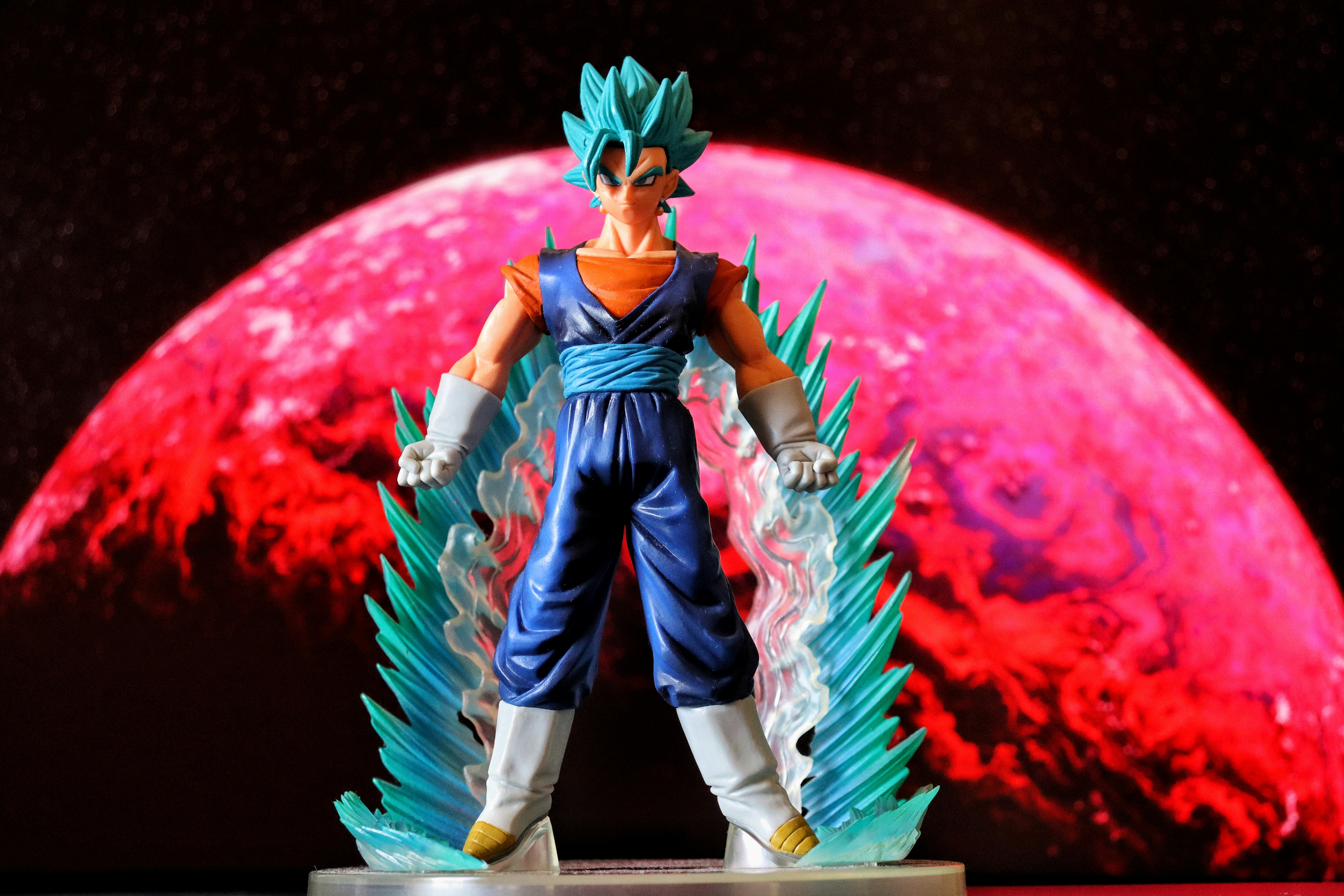 Blue-haired anime figure with energy blasts