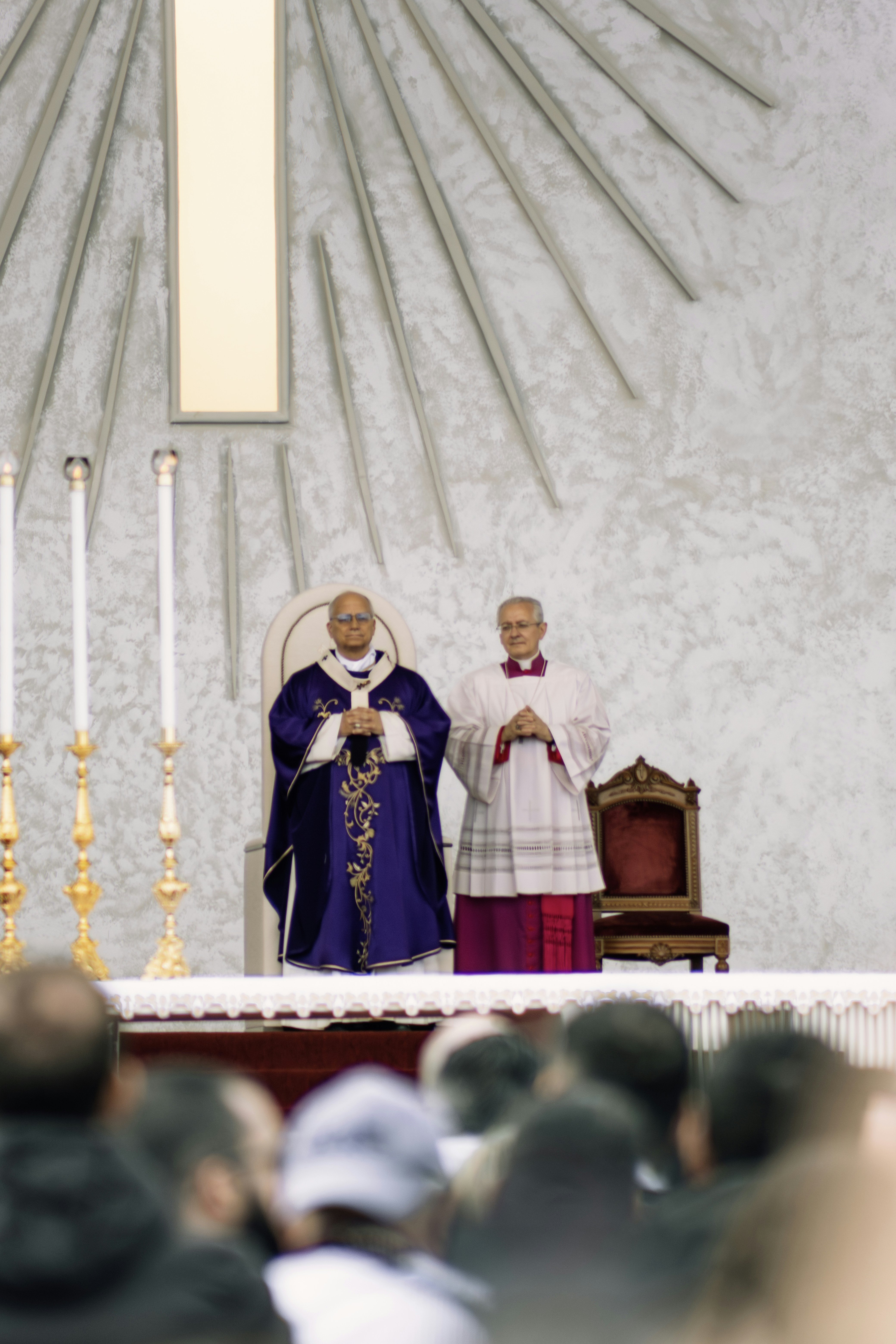 Two clergymen stand at an altar during a religious service