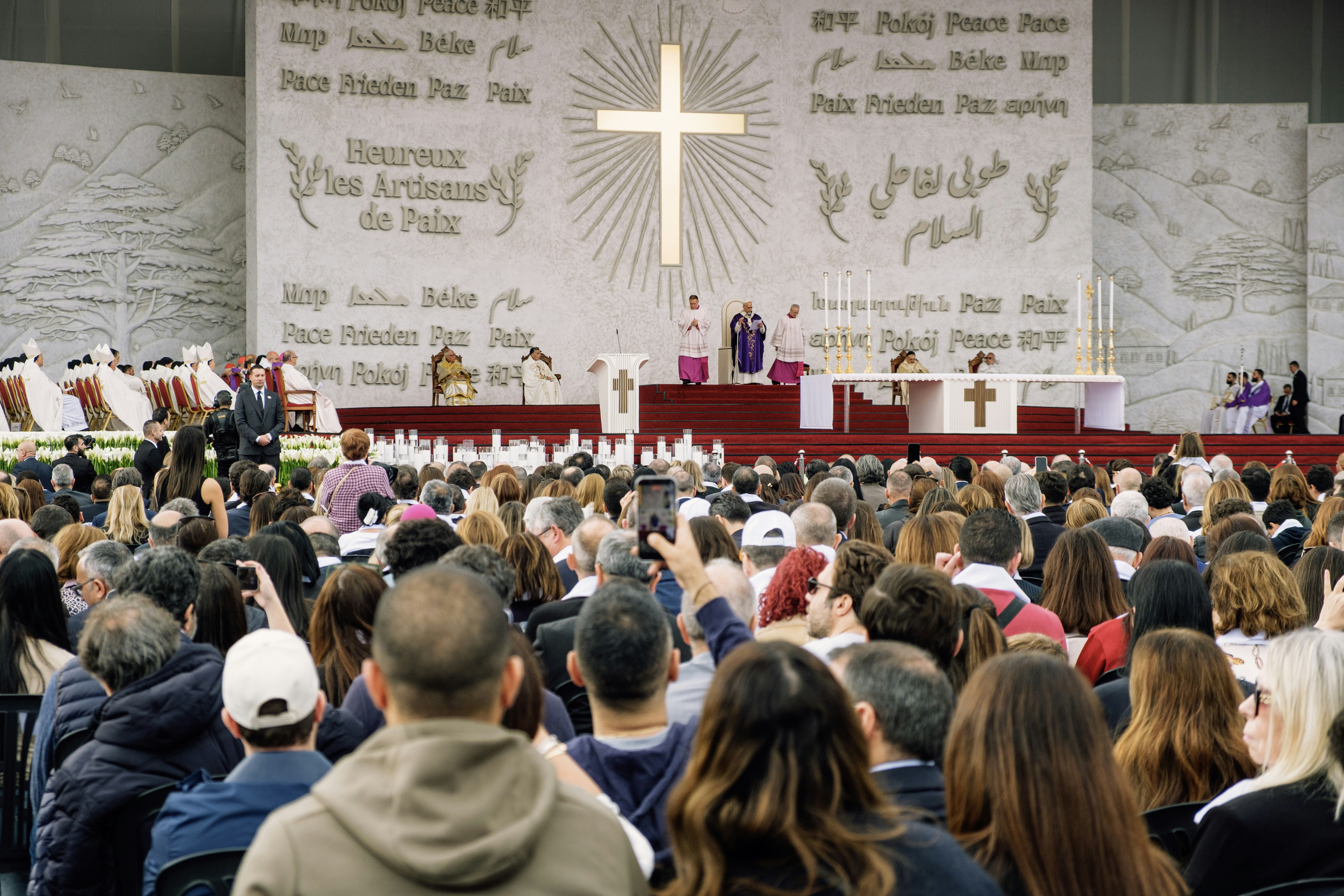 A religious ceremony with a large crowd gathered