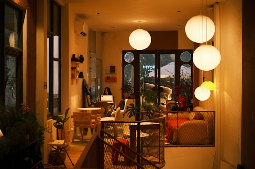 Cozy cafe interior with warm lighting and seating areas.