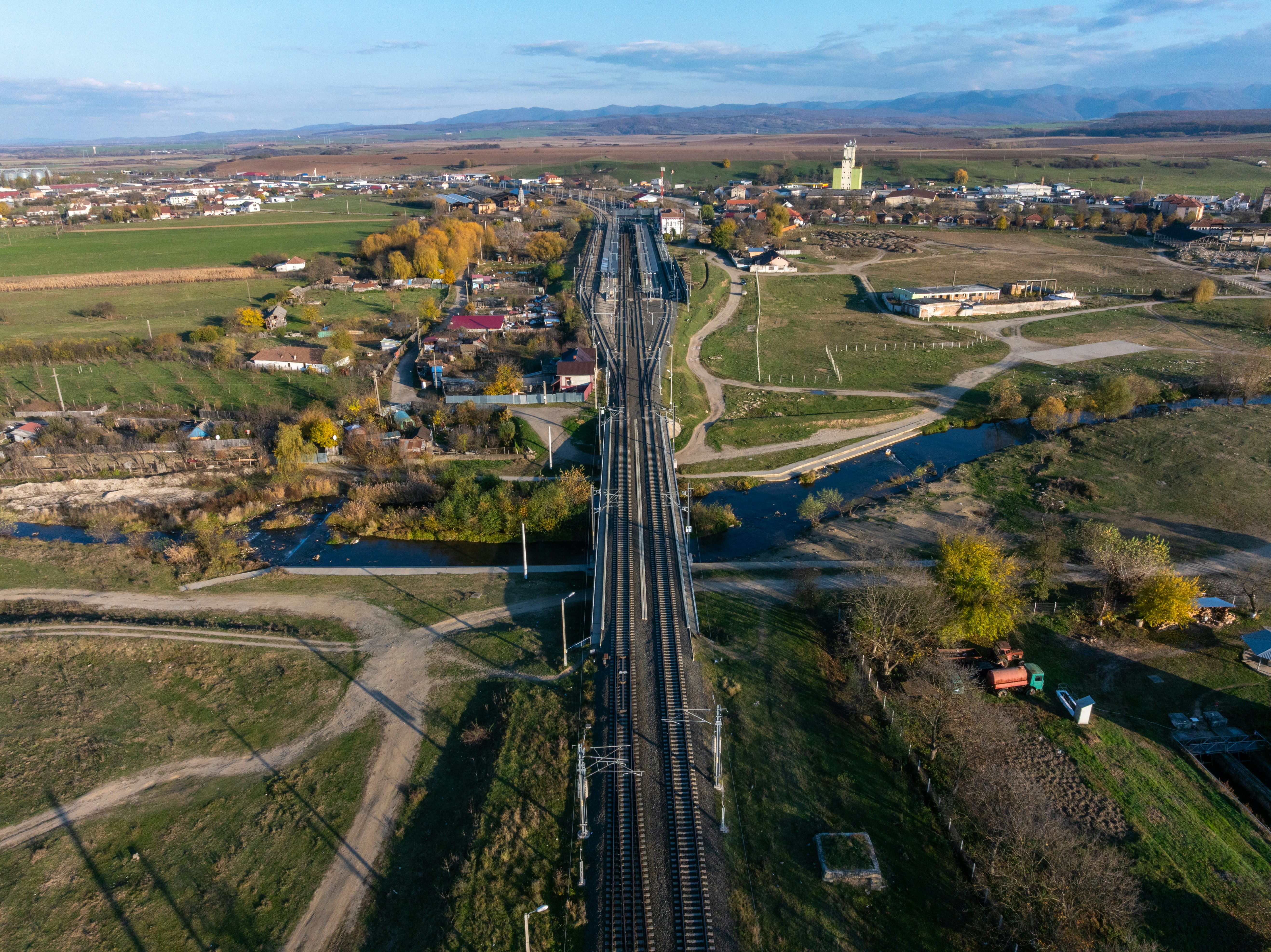 Aerial view of a train track crossing a rural landscape.