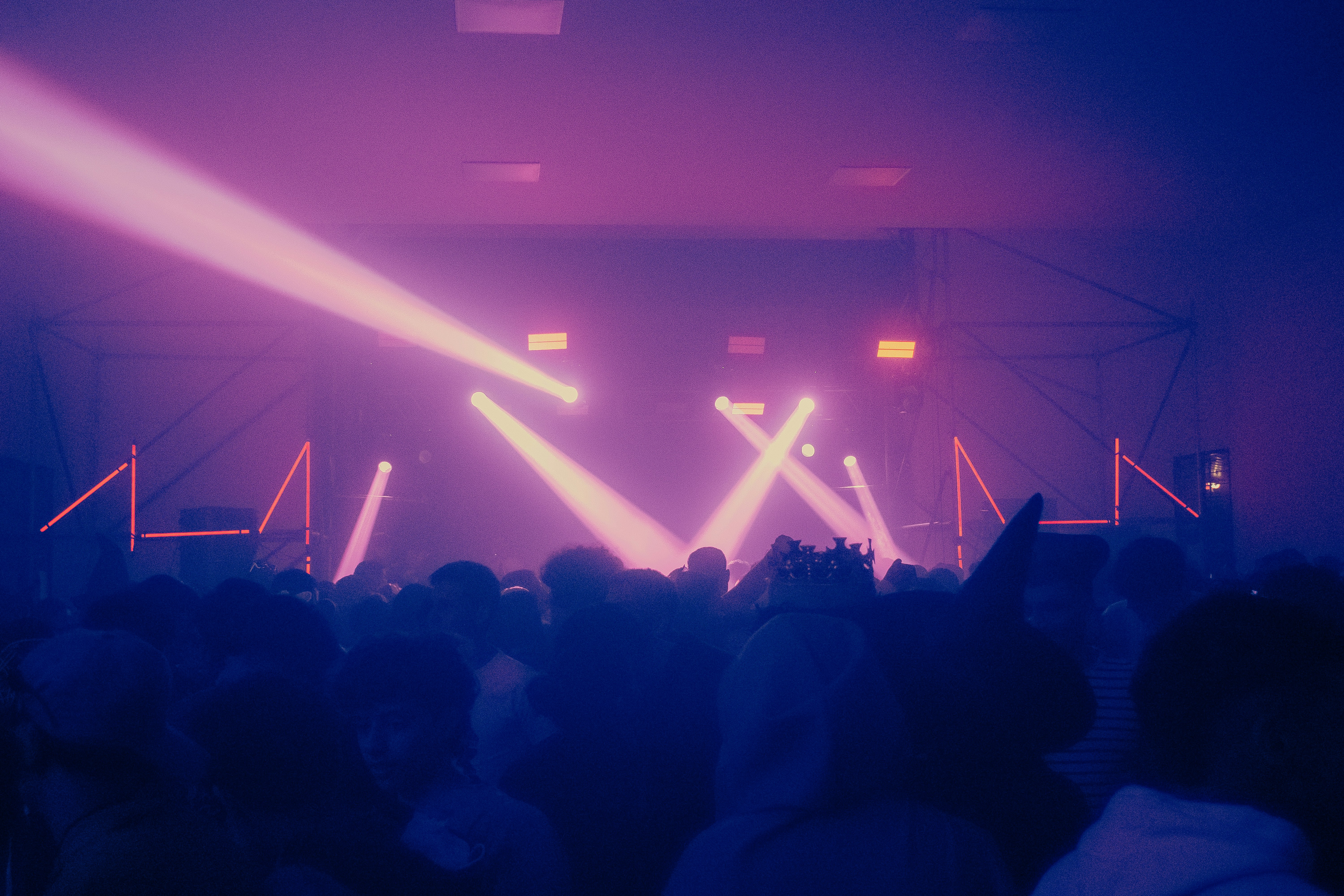 Concert crowd illuminated by bright stage lights