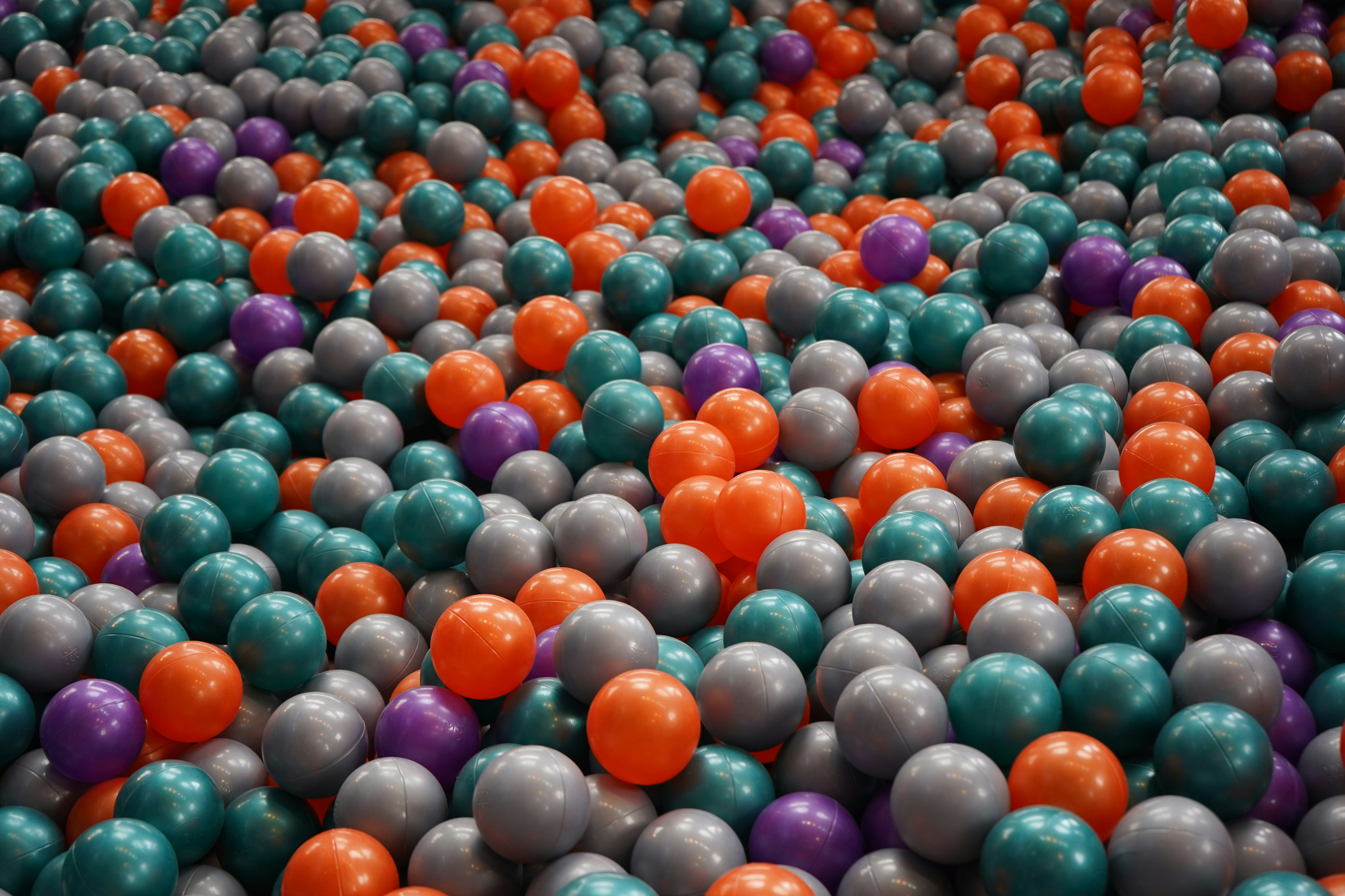 Un tas de boules en plastique colorées dans une fosse à balles.