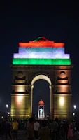 India gate illuminated with tricolor lights at night