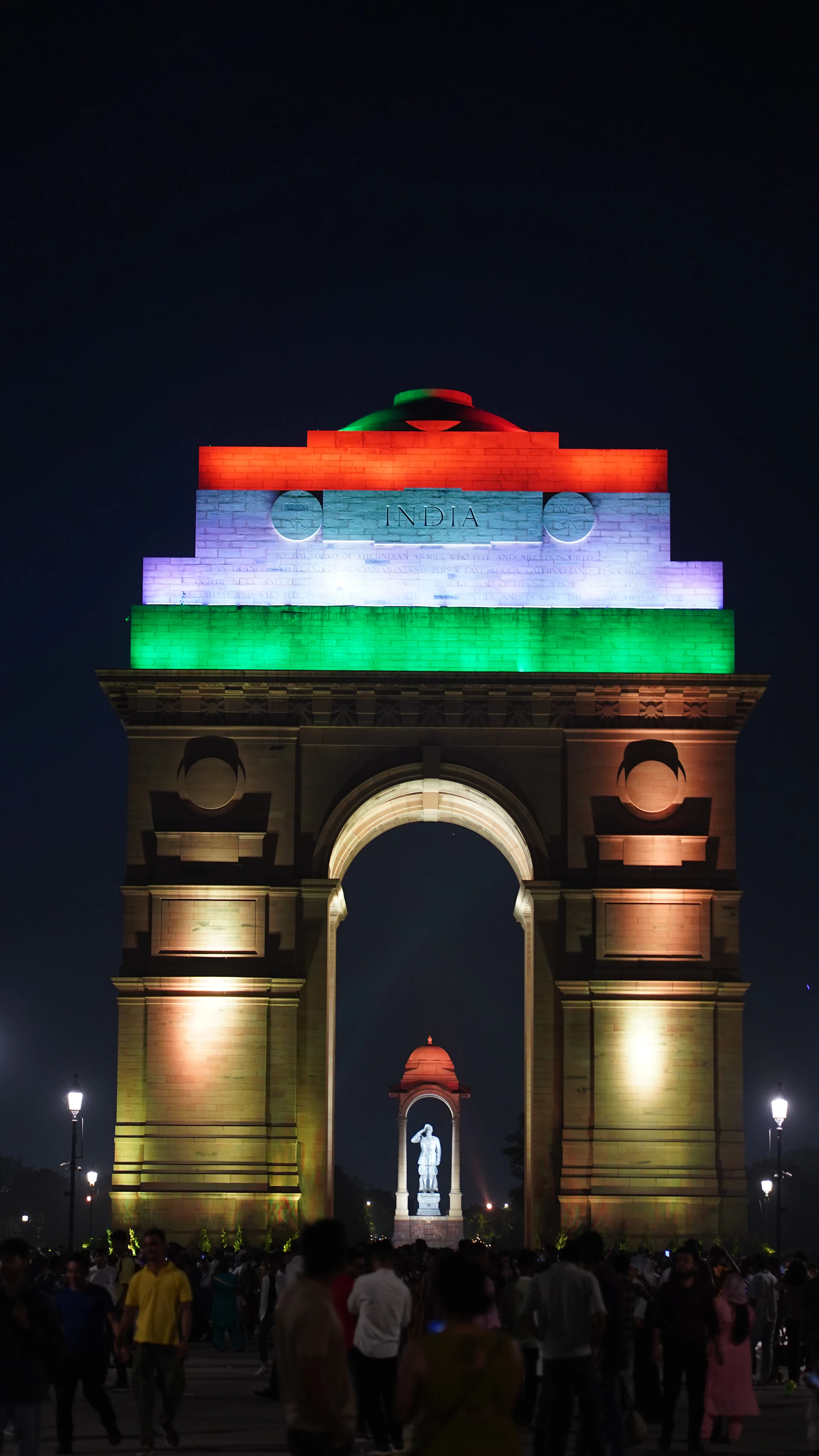 India gate illuminated with tricolor lights at night