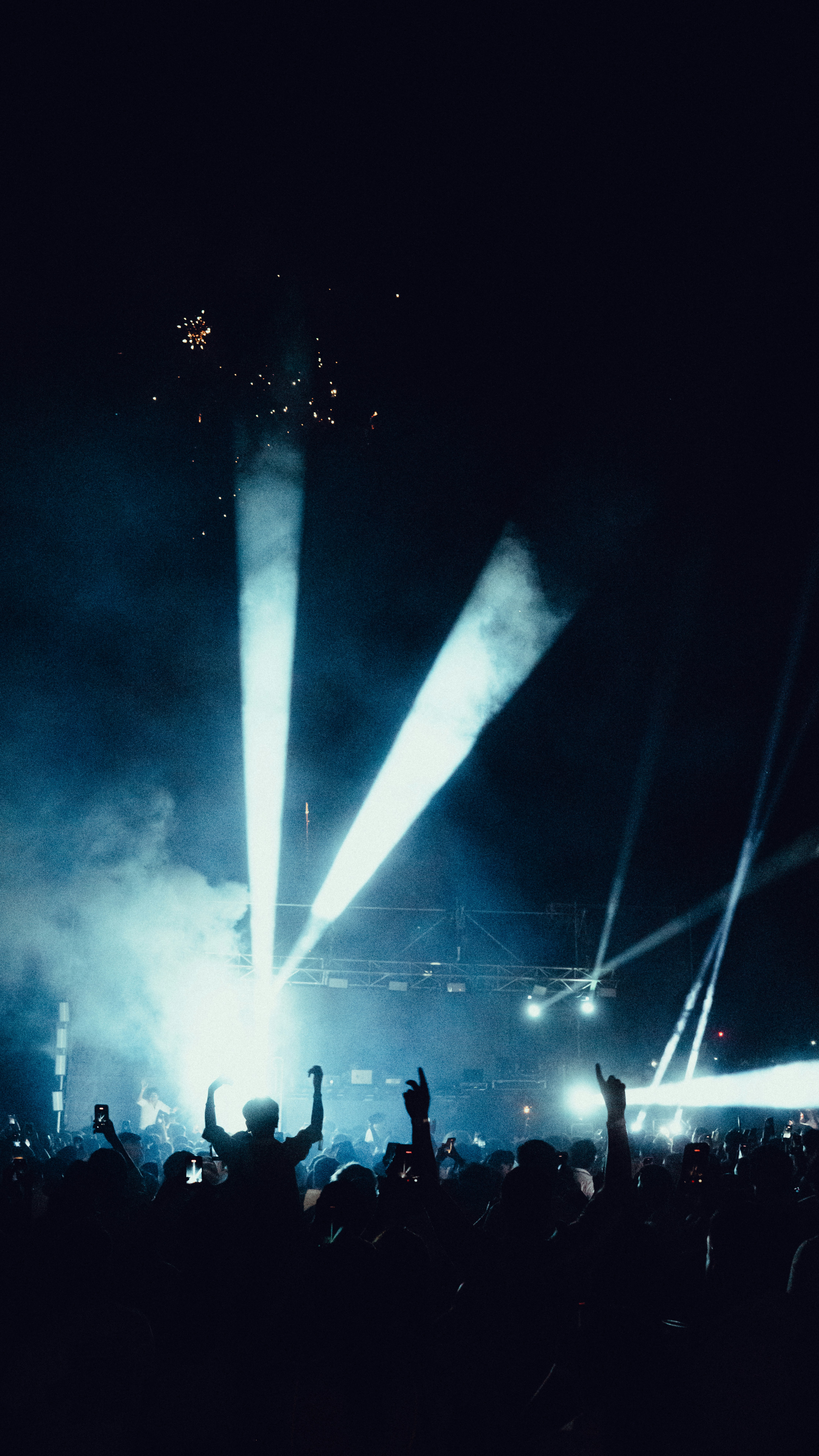Crowd enjoying a concert with bright stage lights