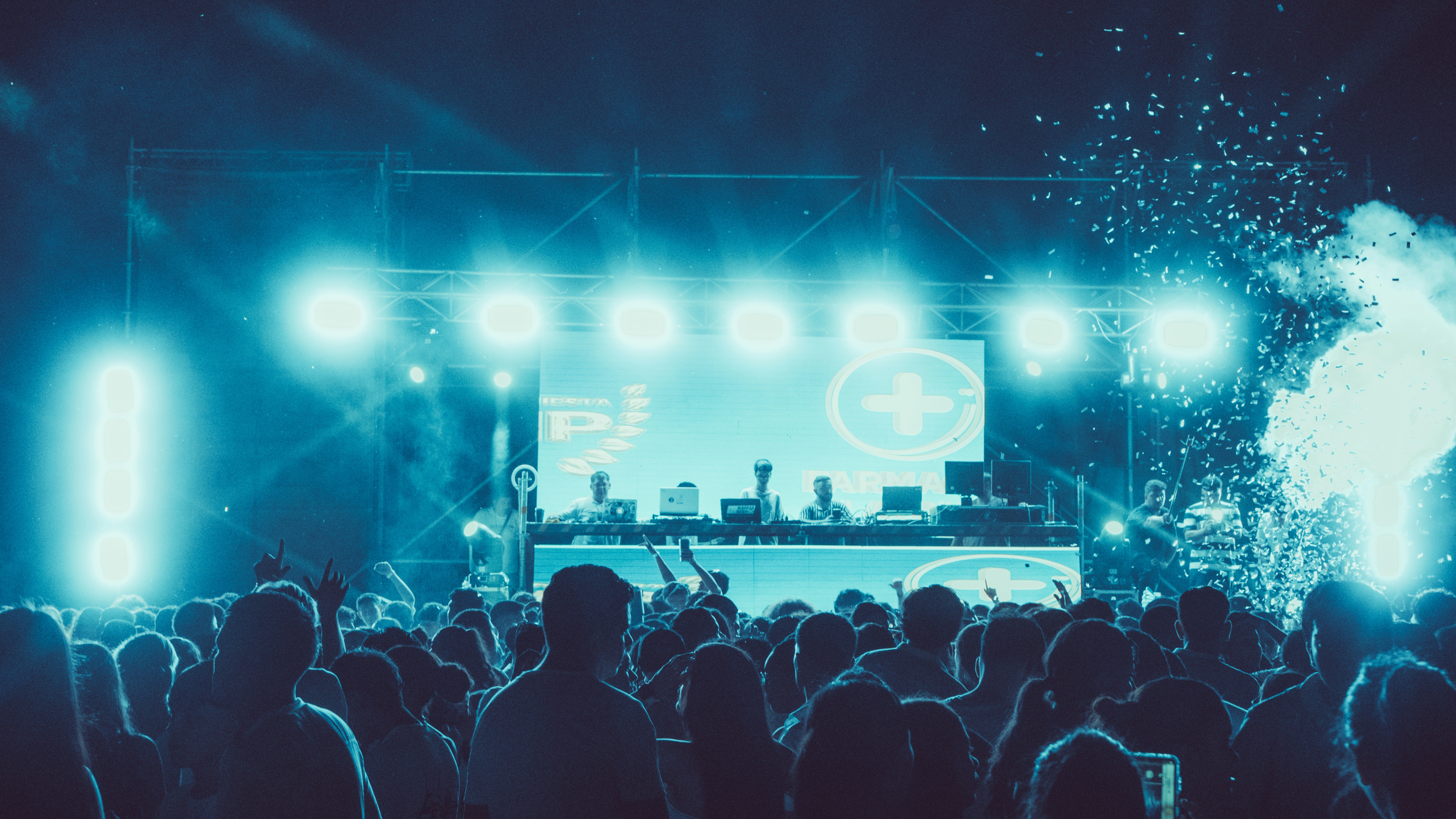 Crowd enjoying a concert with bright stage lights