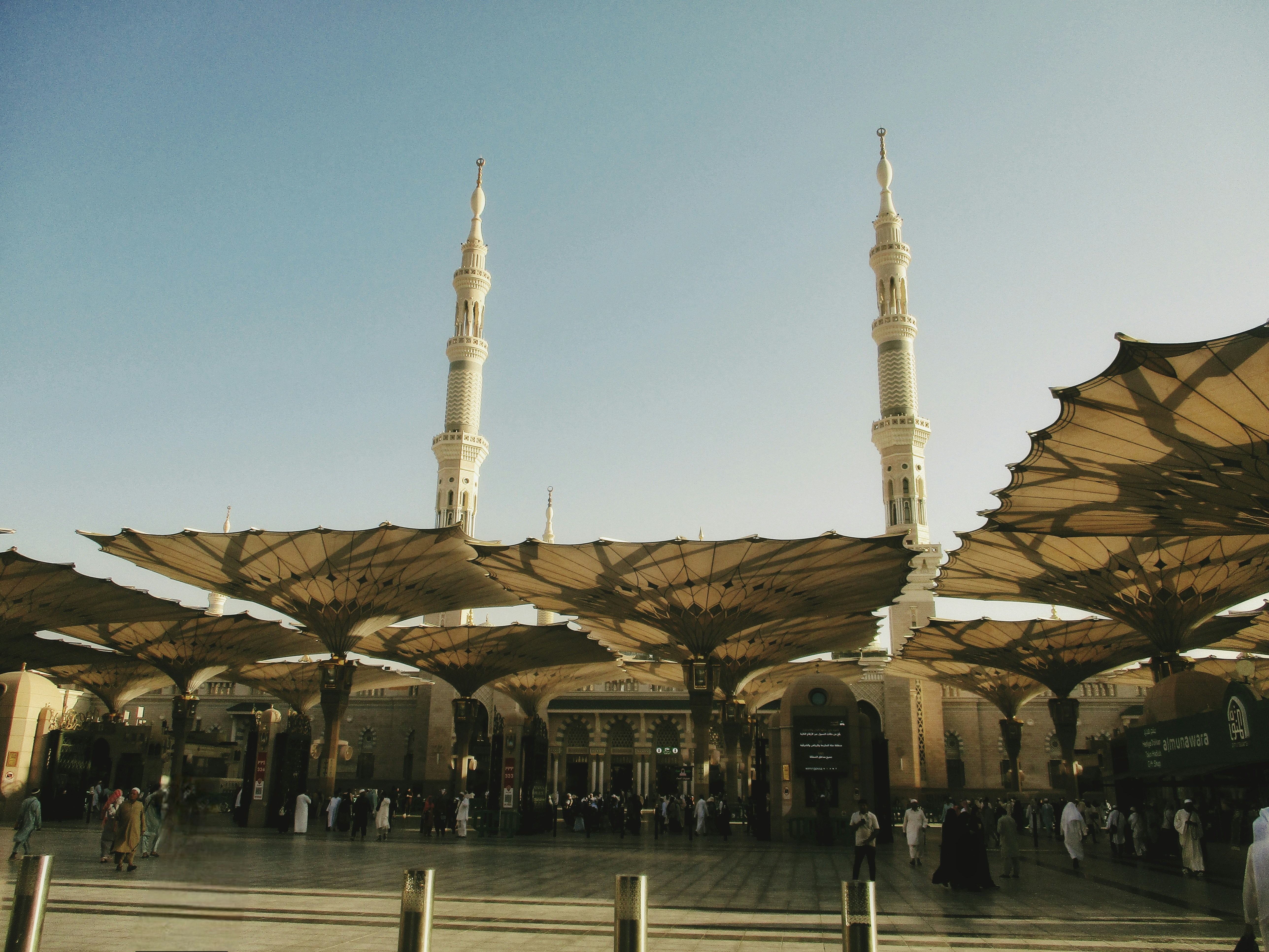 Mosque with tall minarets and large sun umbrellas