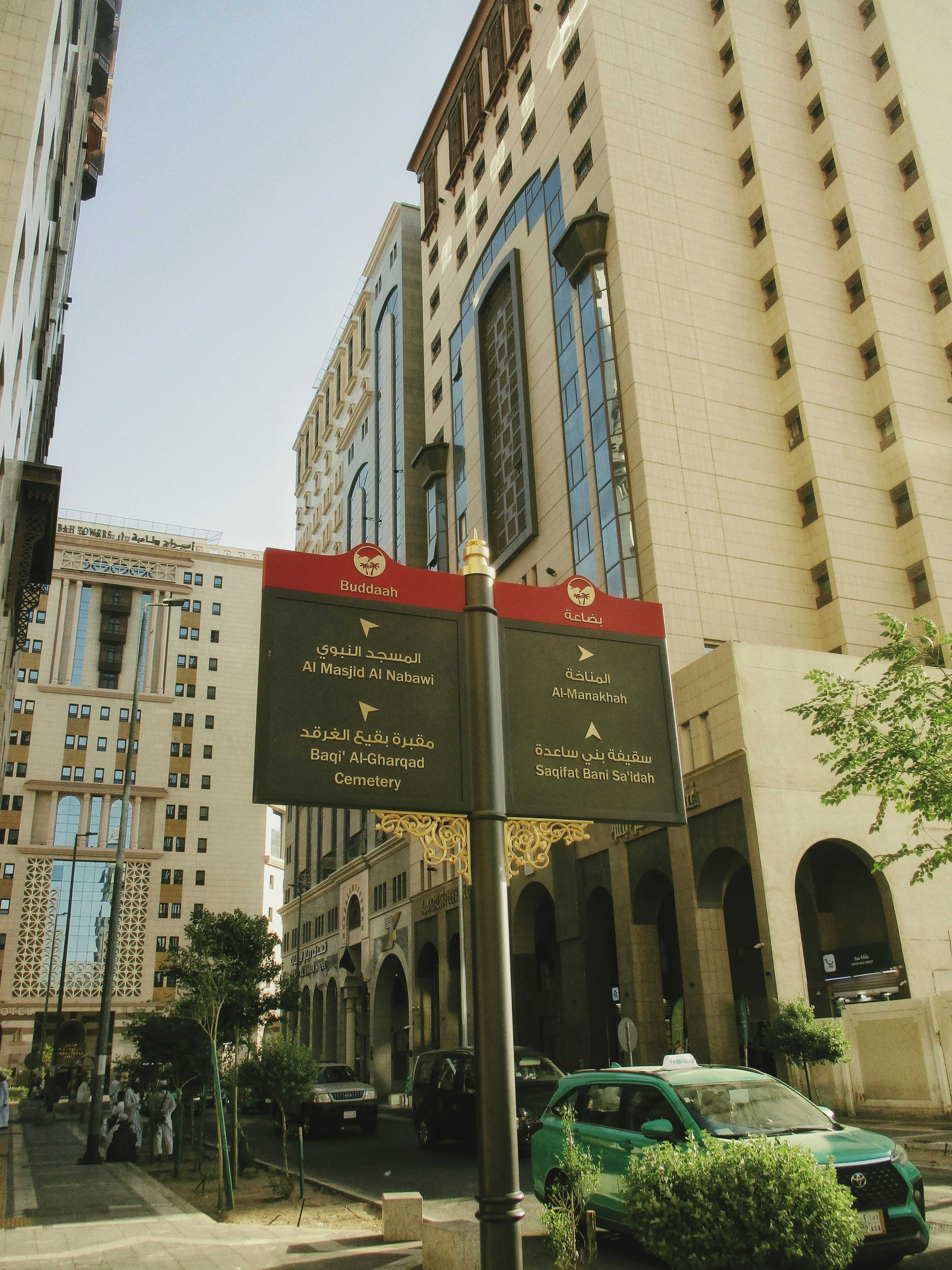 Street signs point towards destinations in a city.