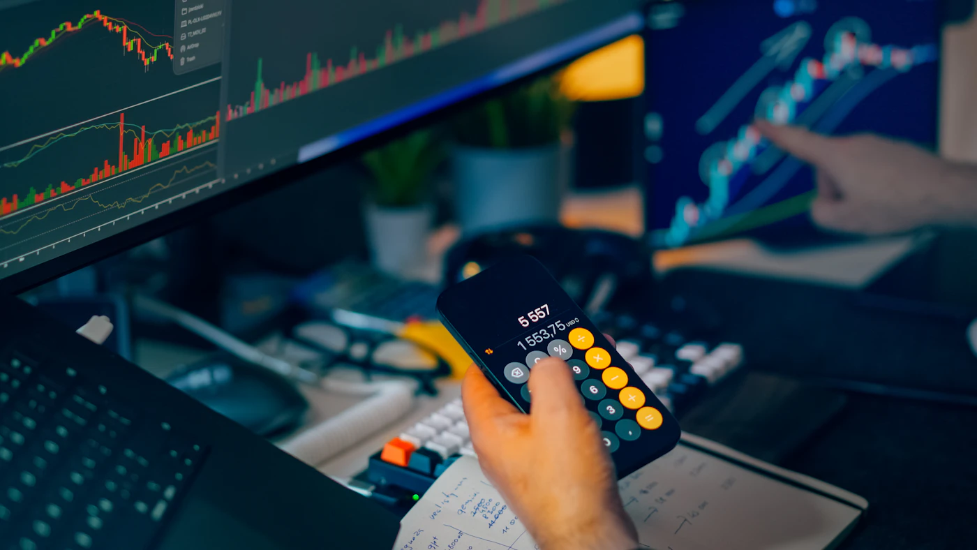 Modern fintech trading workstation with multiple stock market charts smartphone and financial analysis screens