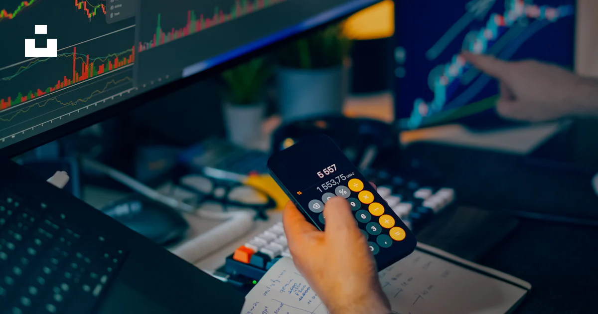 Trader analyzing stock market charts at a desk