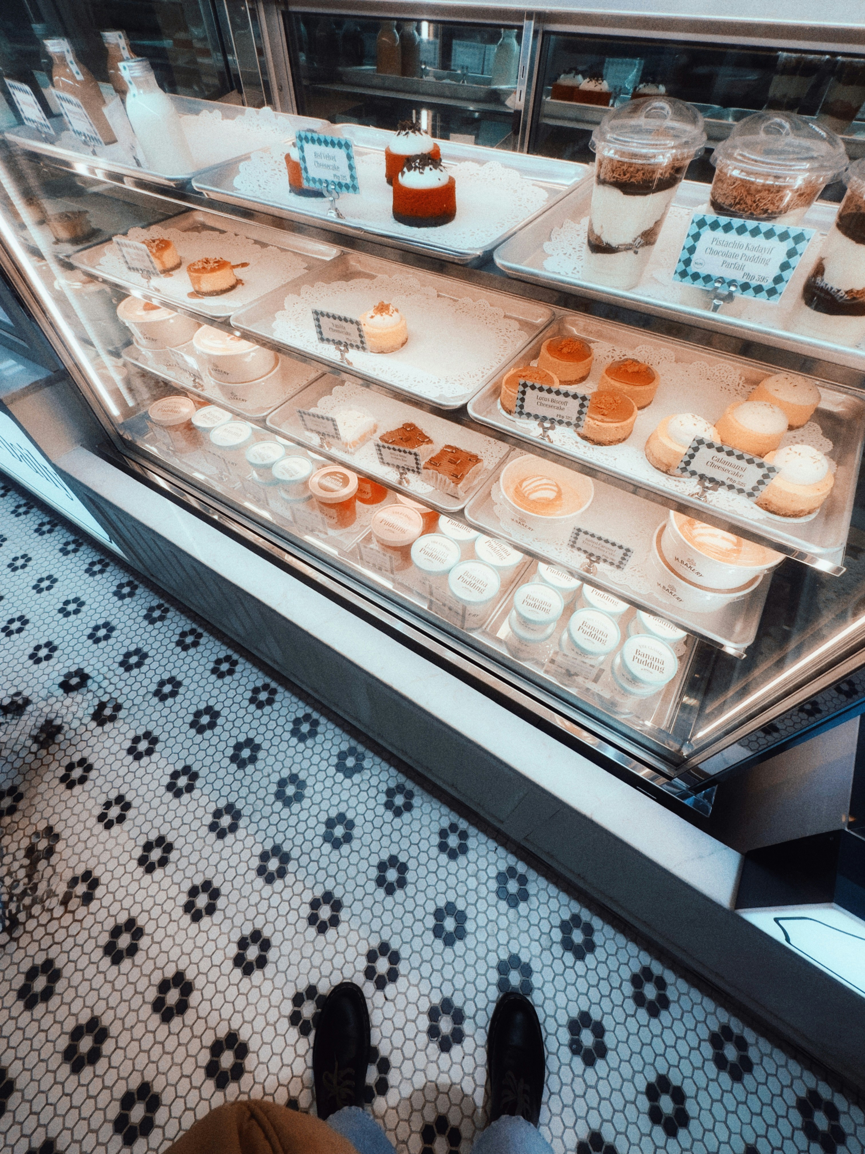 Desserts displayed in a refrigerated bakery case.