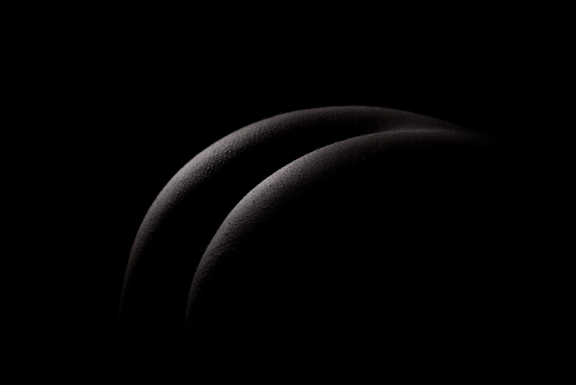 Two curved abstract shapes in dark background