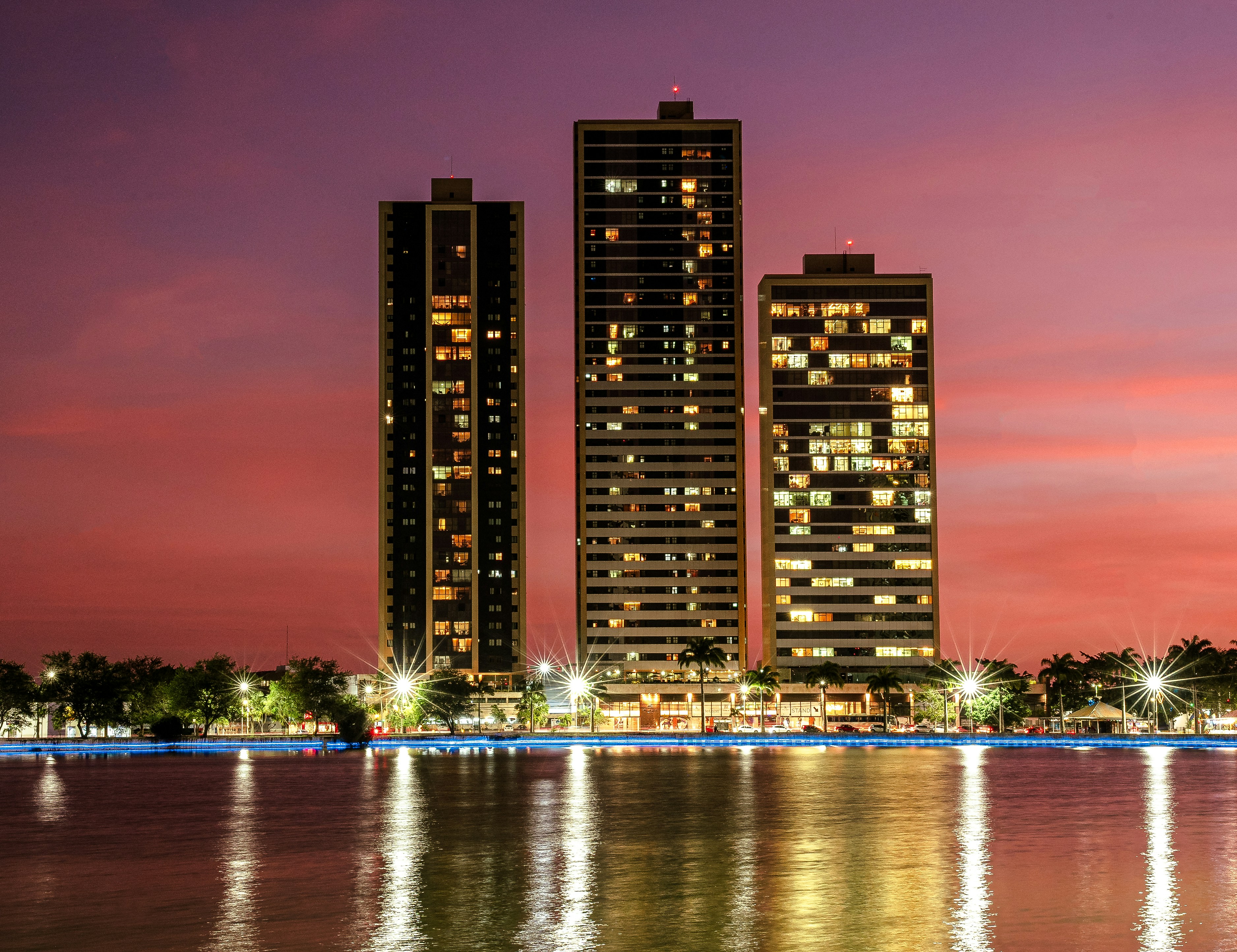 Skyscrapers illuminated at dusk with a colorful sky.