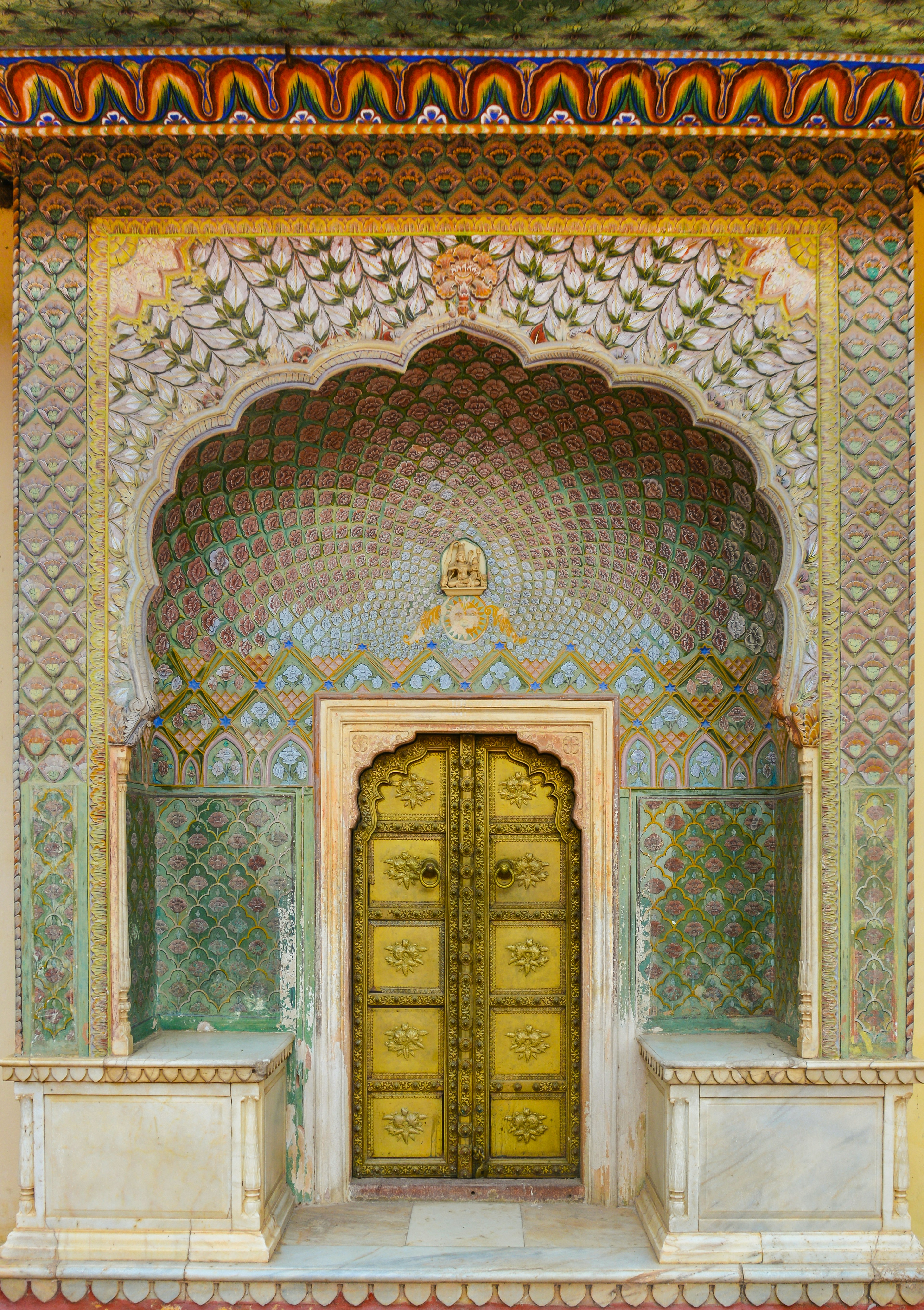 Ornate golden door with intricate indian architectural details
