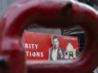 Man featured on a red advertisement board.