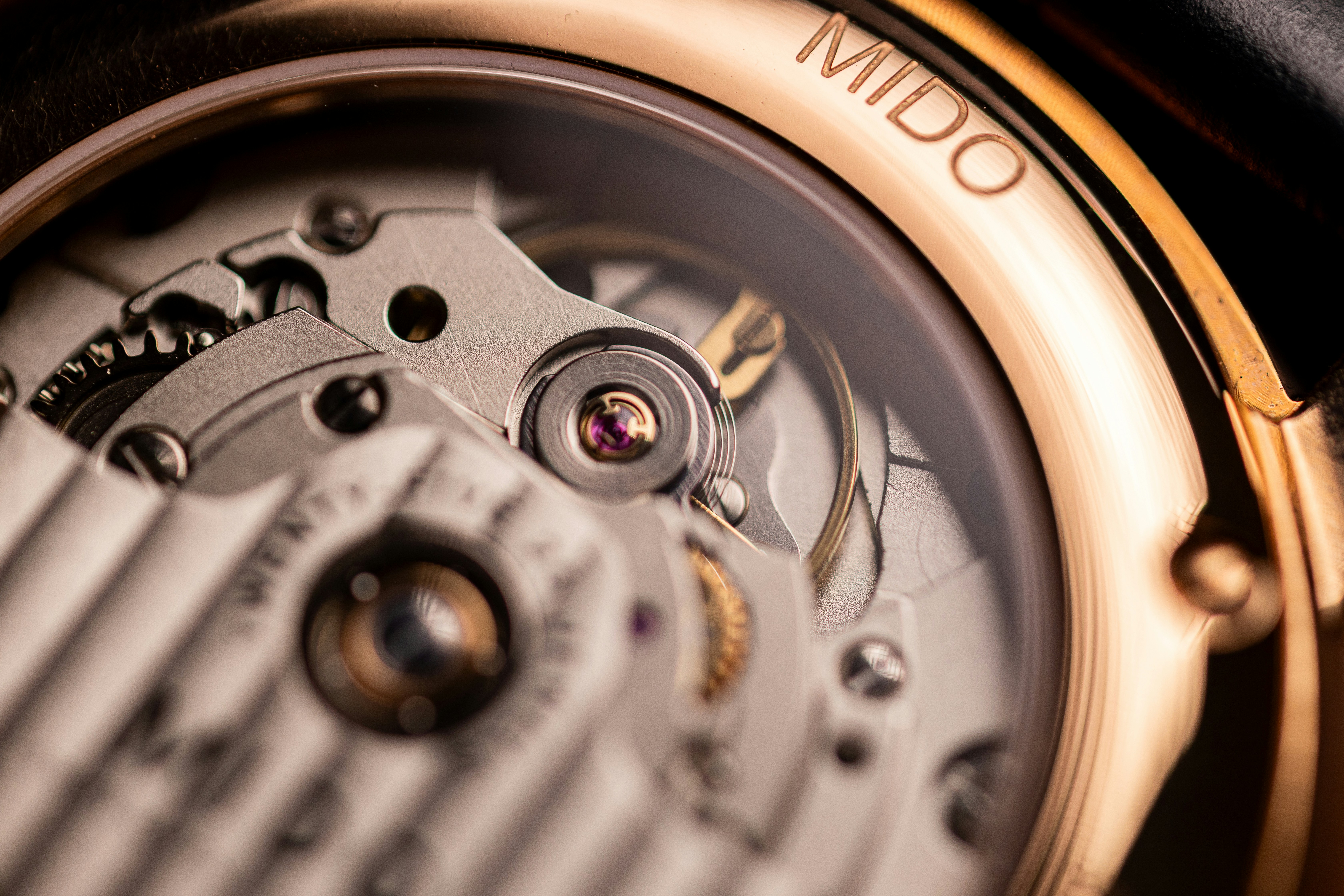 Close-up of a mechanical watch movement with mido branding.