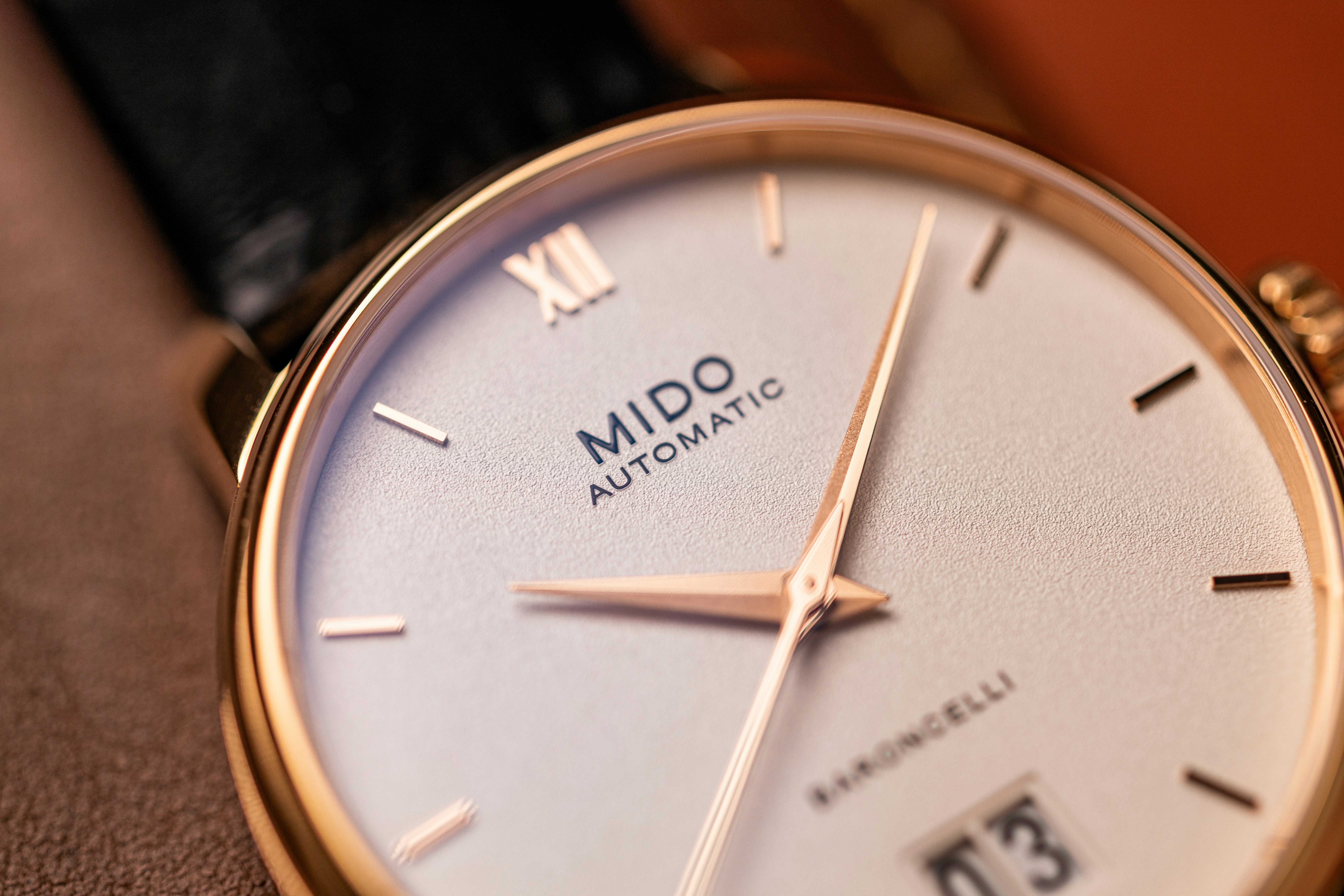 Close-up of a mido automatic wristwatch with date.