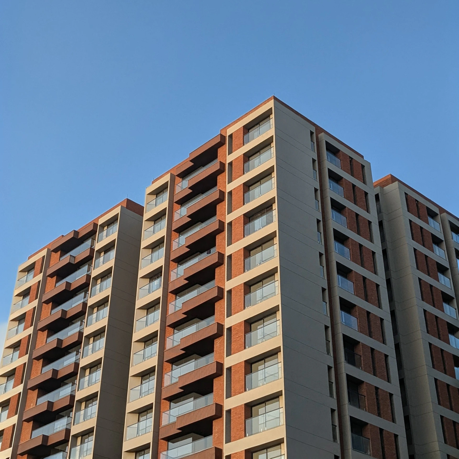 Modern apartment buildings against a clear blue sky