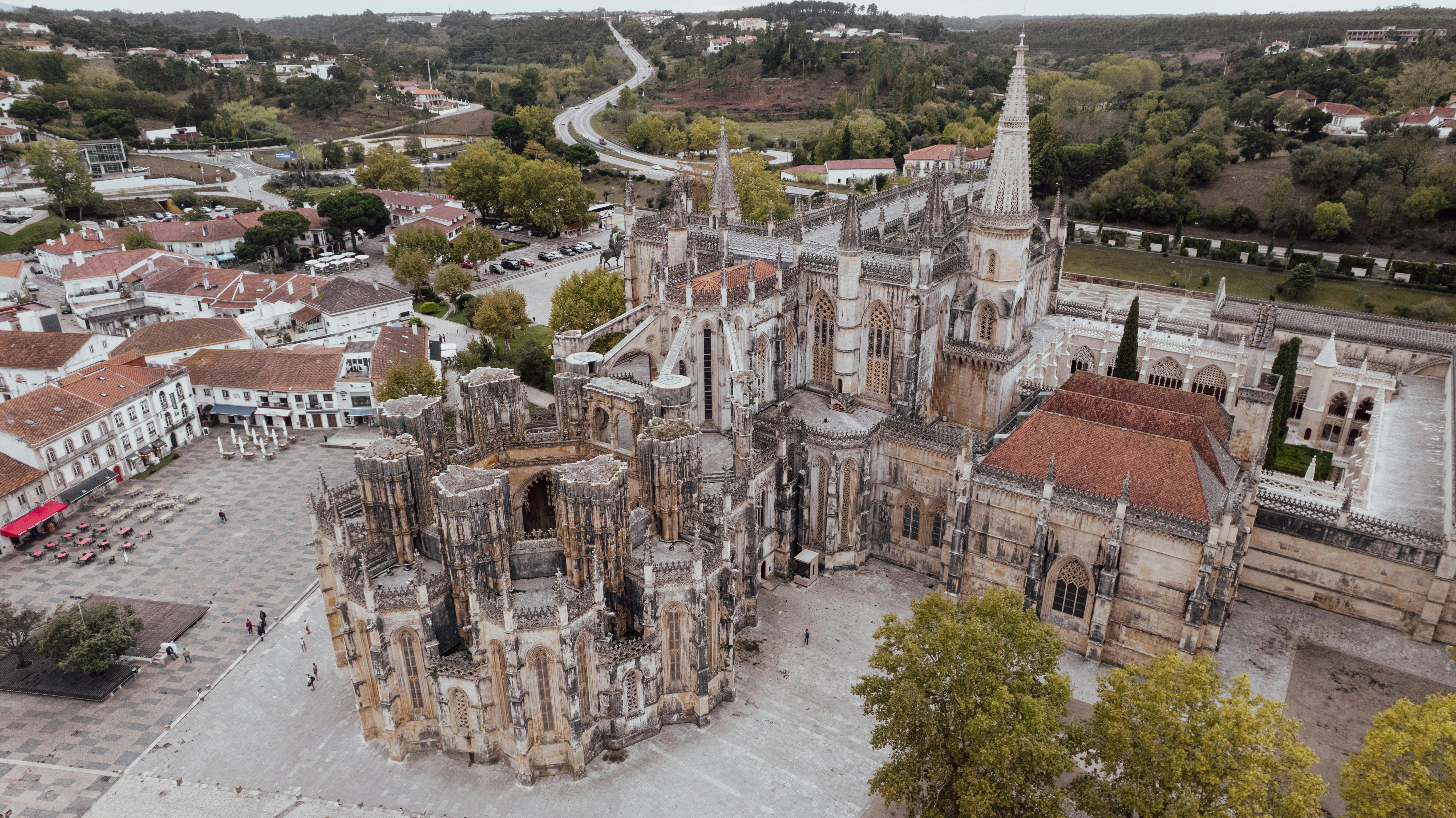 Aerial view of a large gothic cathedral and town square
