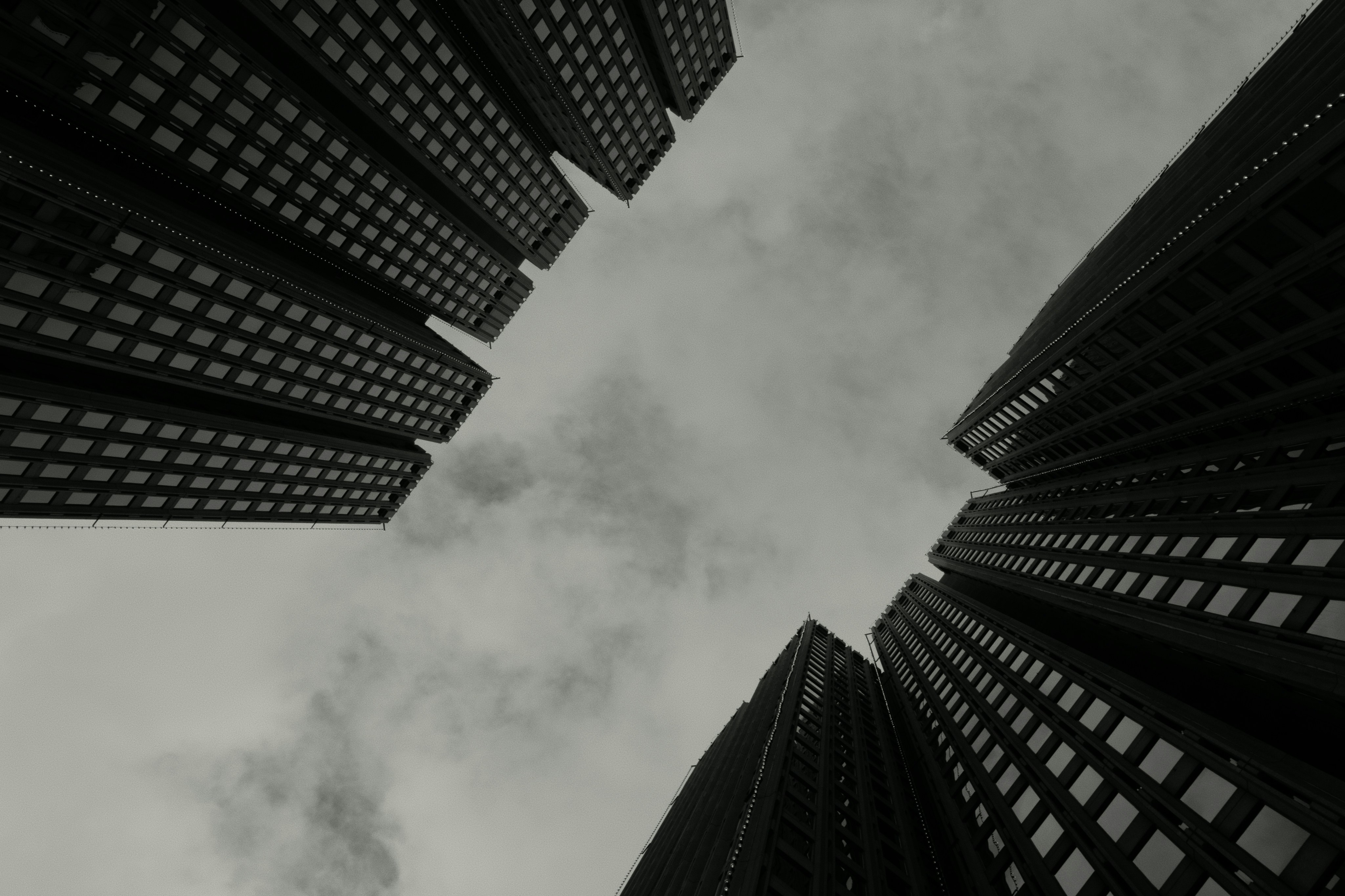 Skyscrapers viewed from below against cloudy sky