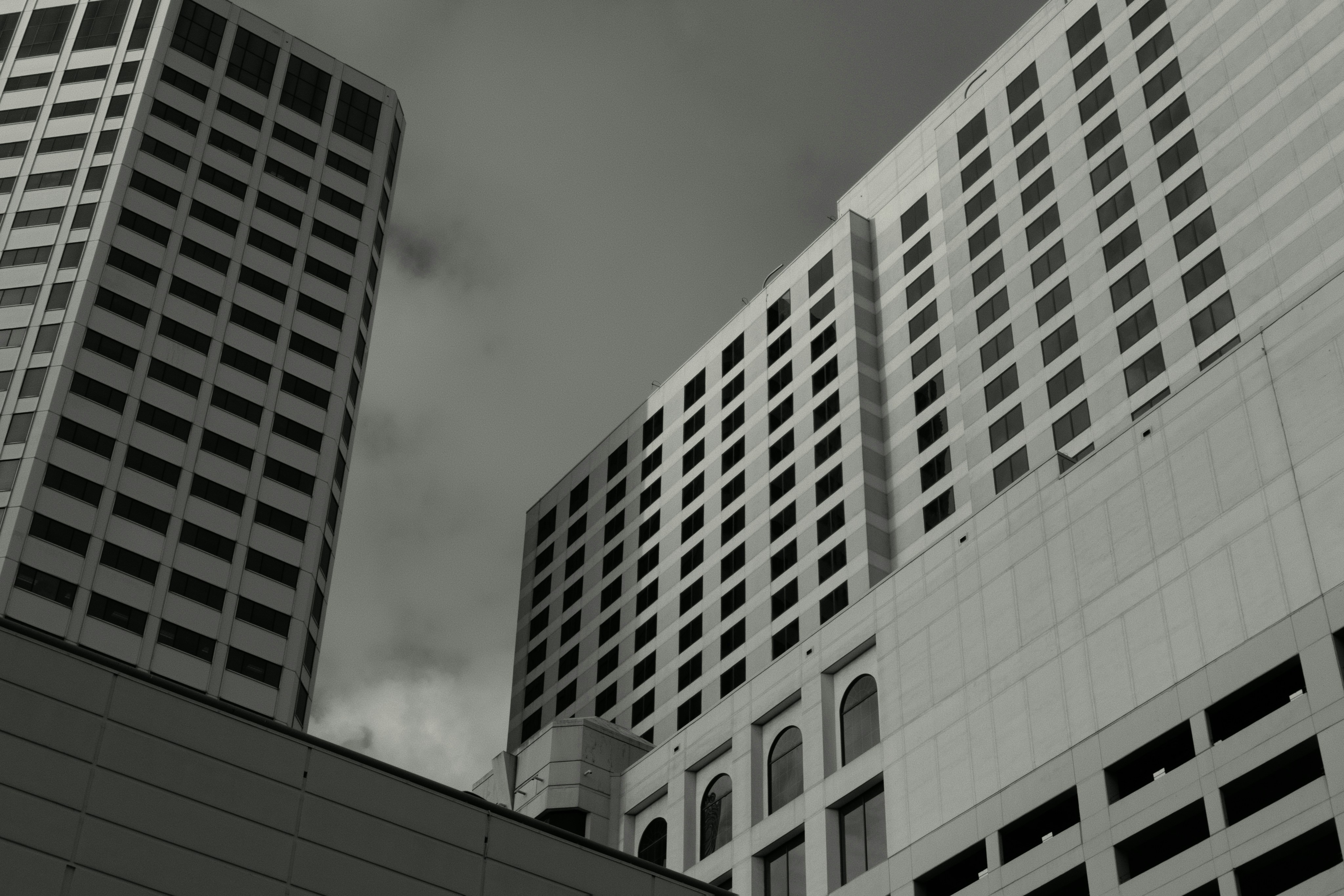 Modern buildings against a cloudy sky.