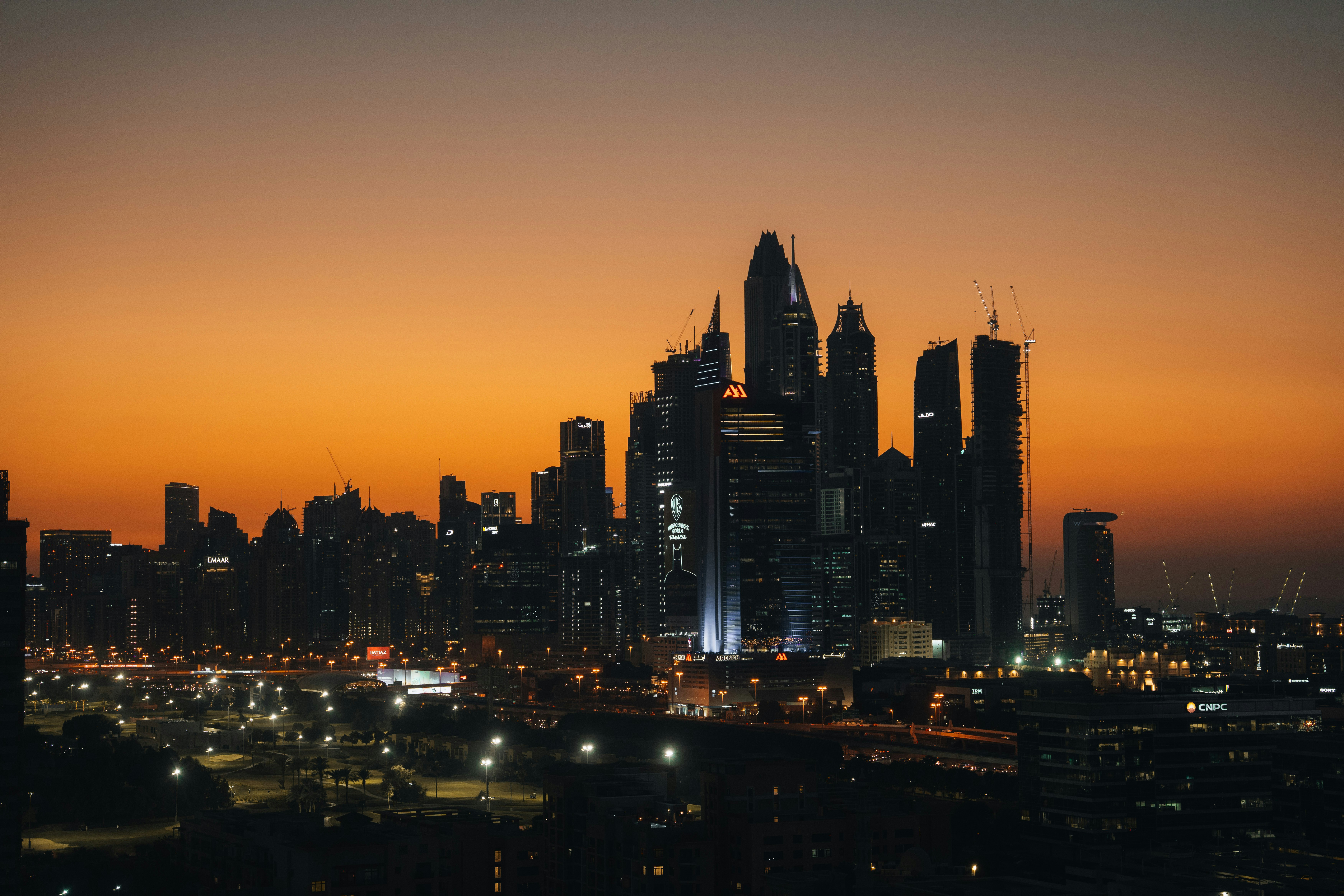City skyline at dusk with orange sky